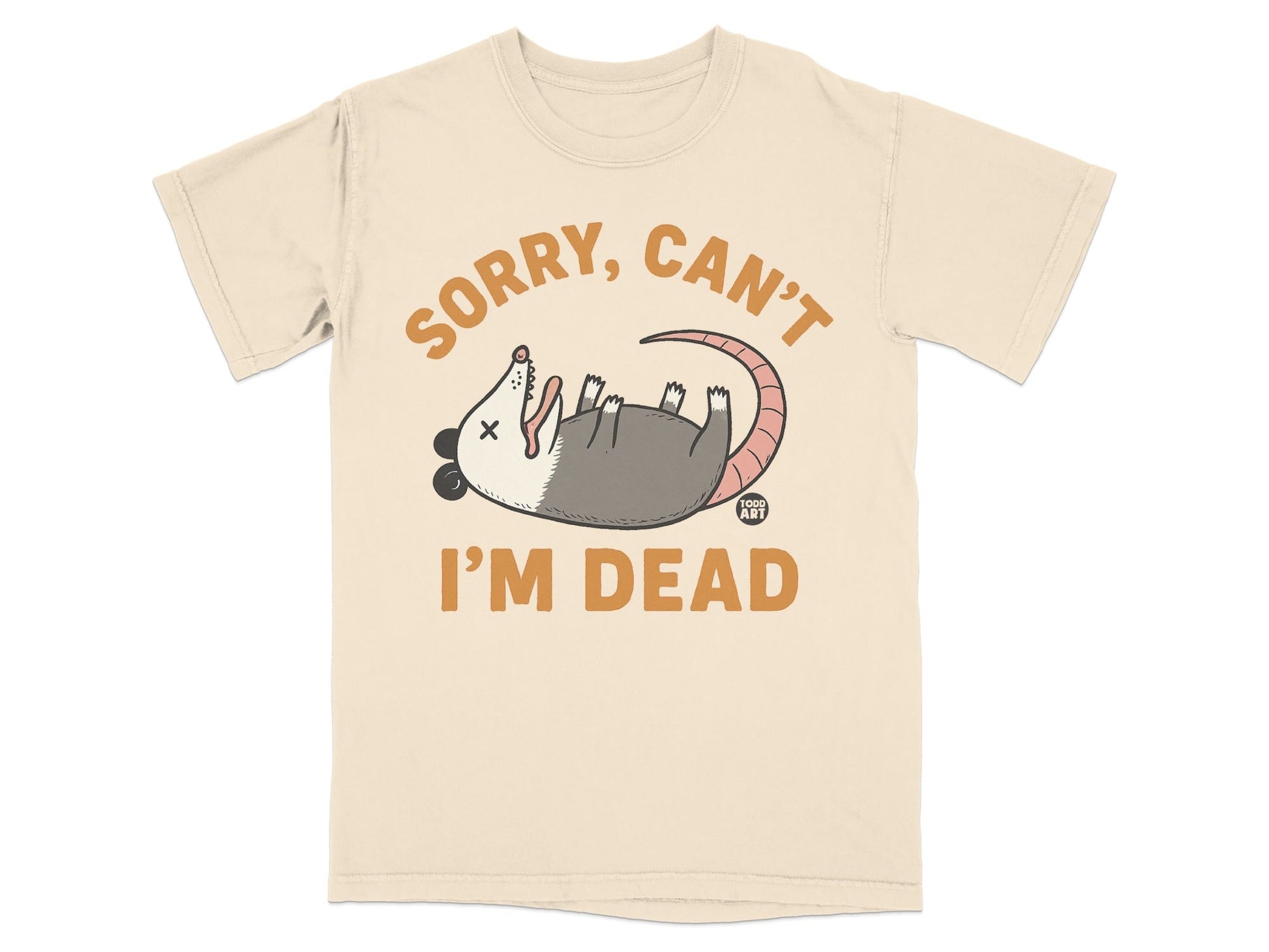 Cream t-shirt with cartoon opossum playing dead and text "SORRY, CAN'T I'M DEAD".