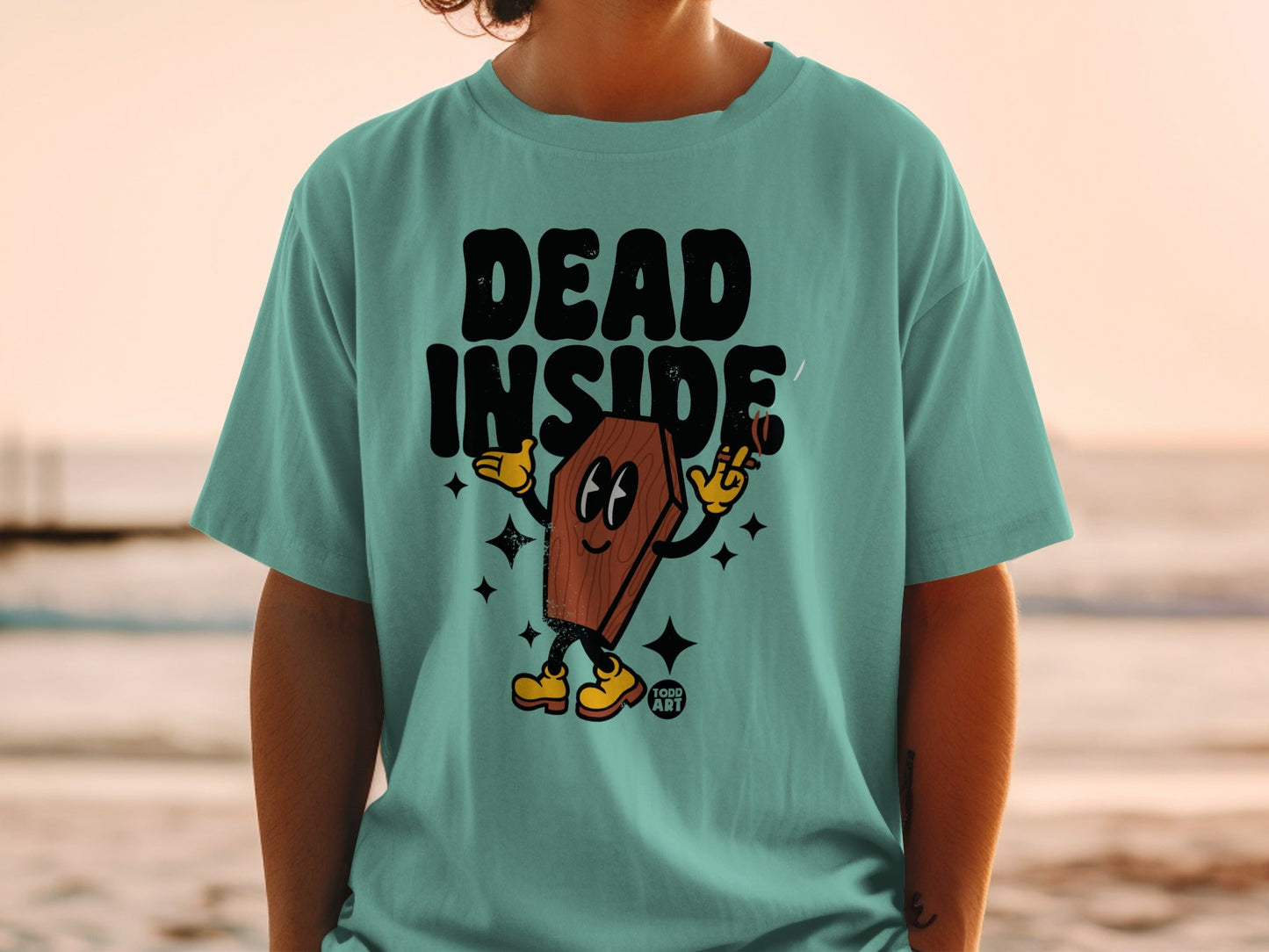 Teal t-shirt with cartoon coffin character that says "DEAD INSIDE".