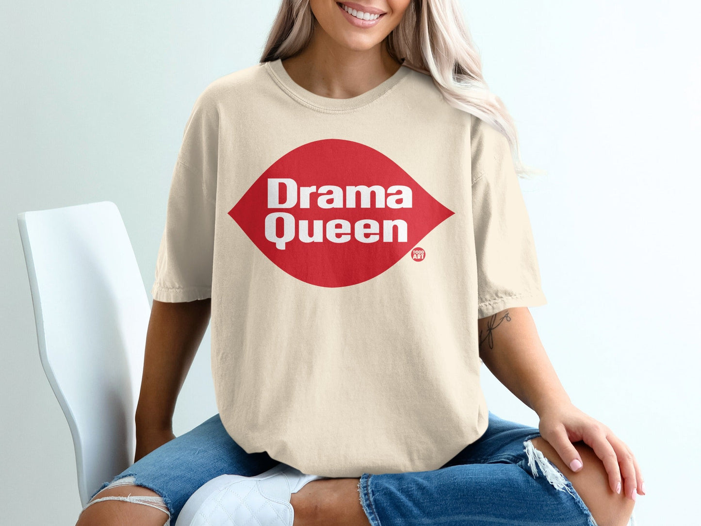 Cream t-shirt with red "Drama Queen" graphic on chest.