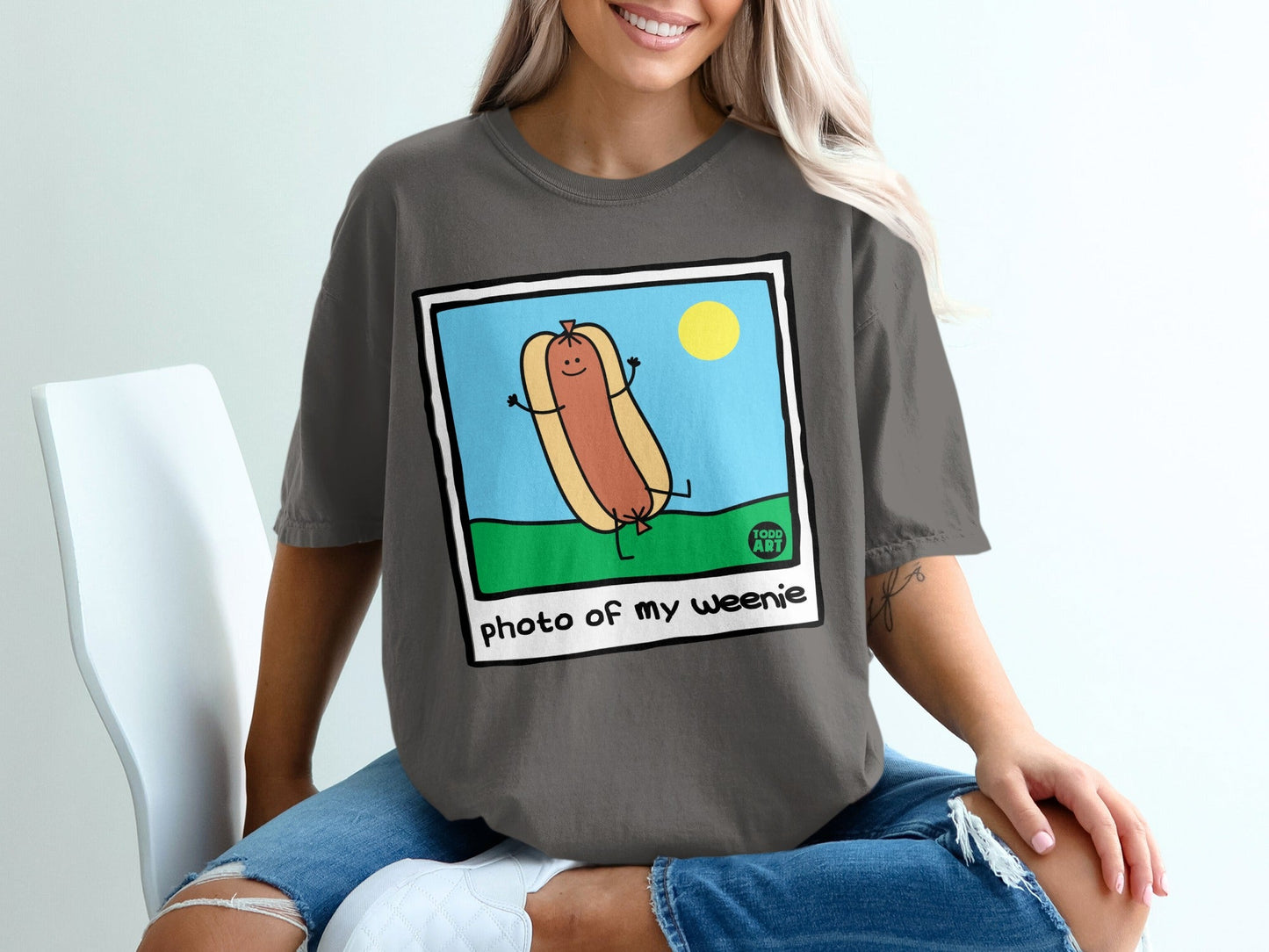 Cartoon hot dog with arms and legs, smiling in a field under a sun.