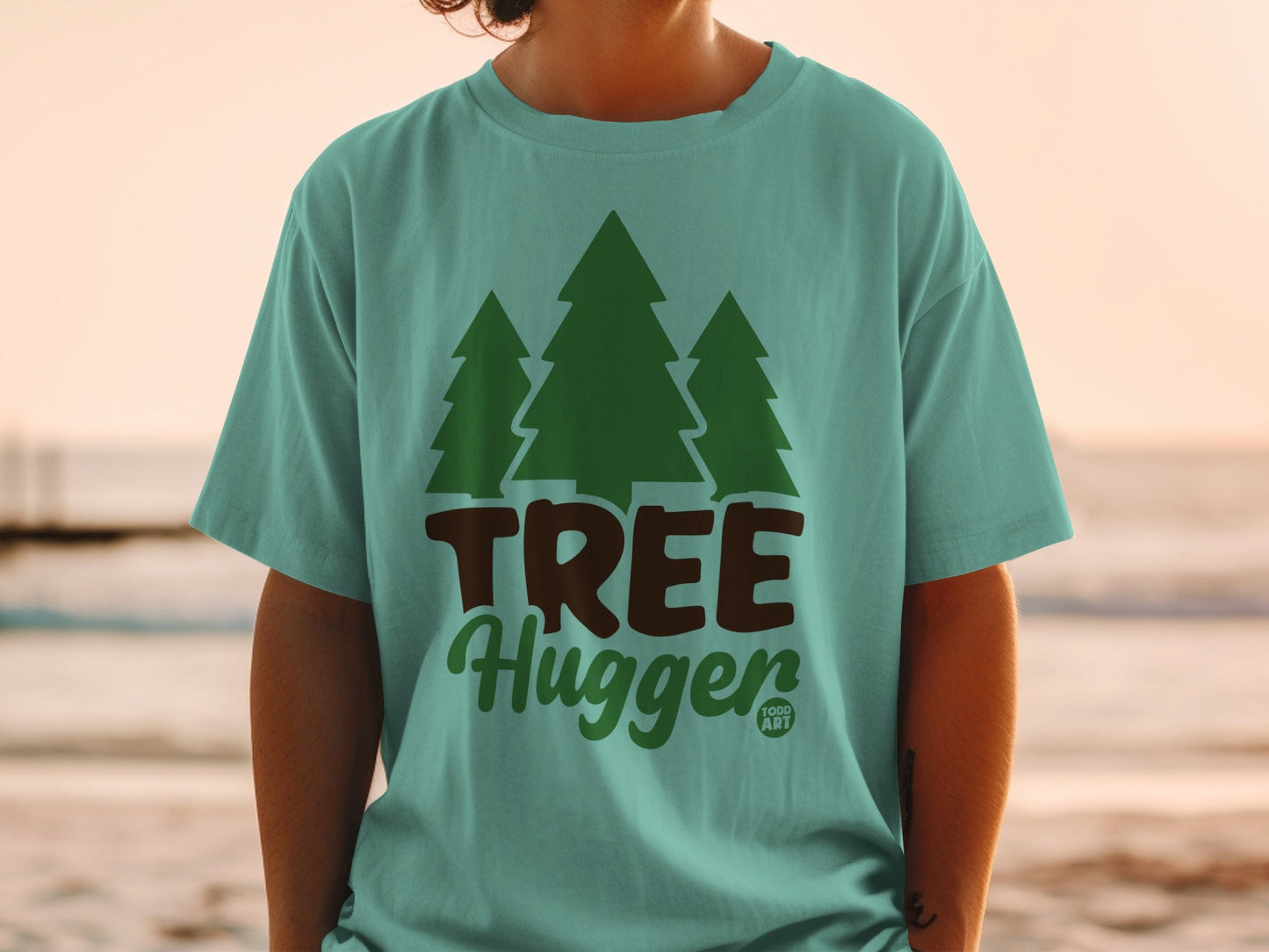Teal t-shirt with "TREE Hugger" text and three green pine trees.