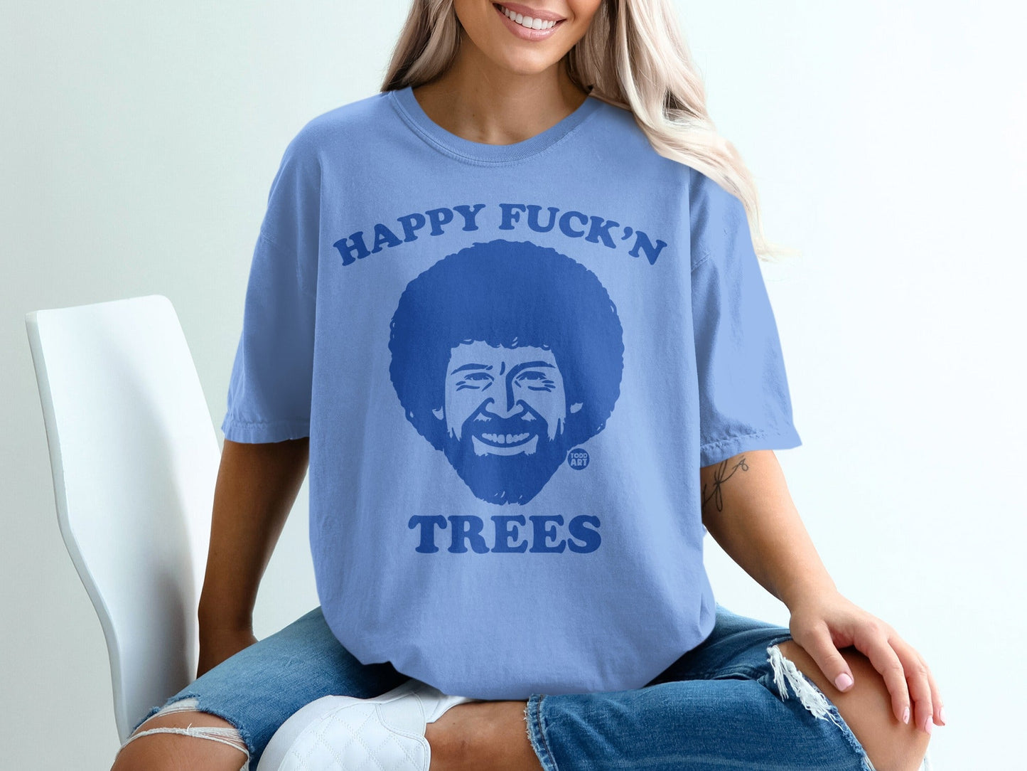 Blue t-shirt with Bob Ross illustration and "Happy Fuck'n Trees" text.