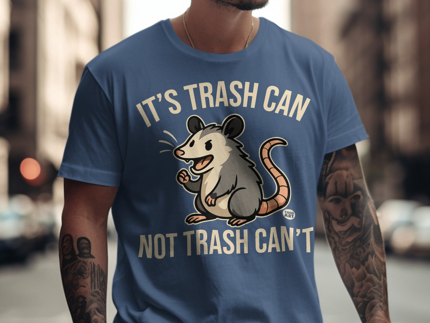 Blue t-shirt with cartoon possum and text "It's trash can not trash can't".