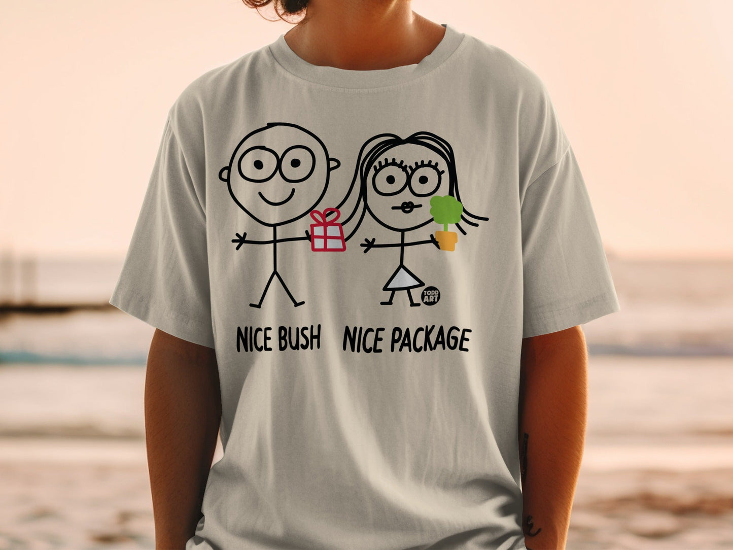 T-shirt with stick figures holding a gift and plant, text "NICE BUSH NICE PACKAGE".