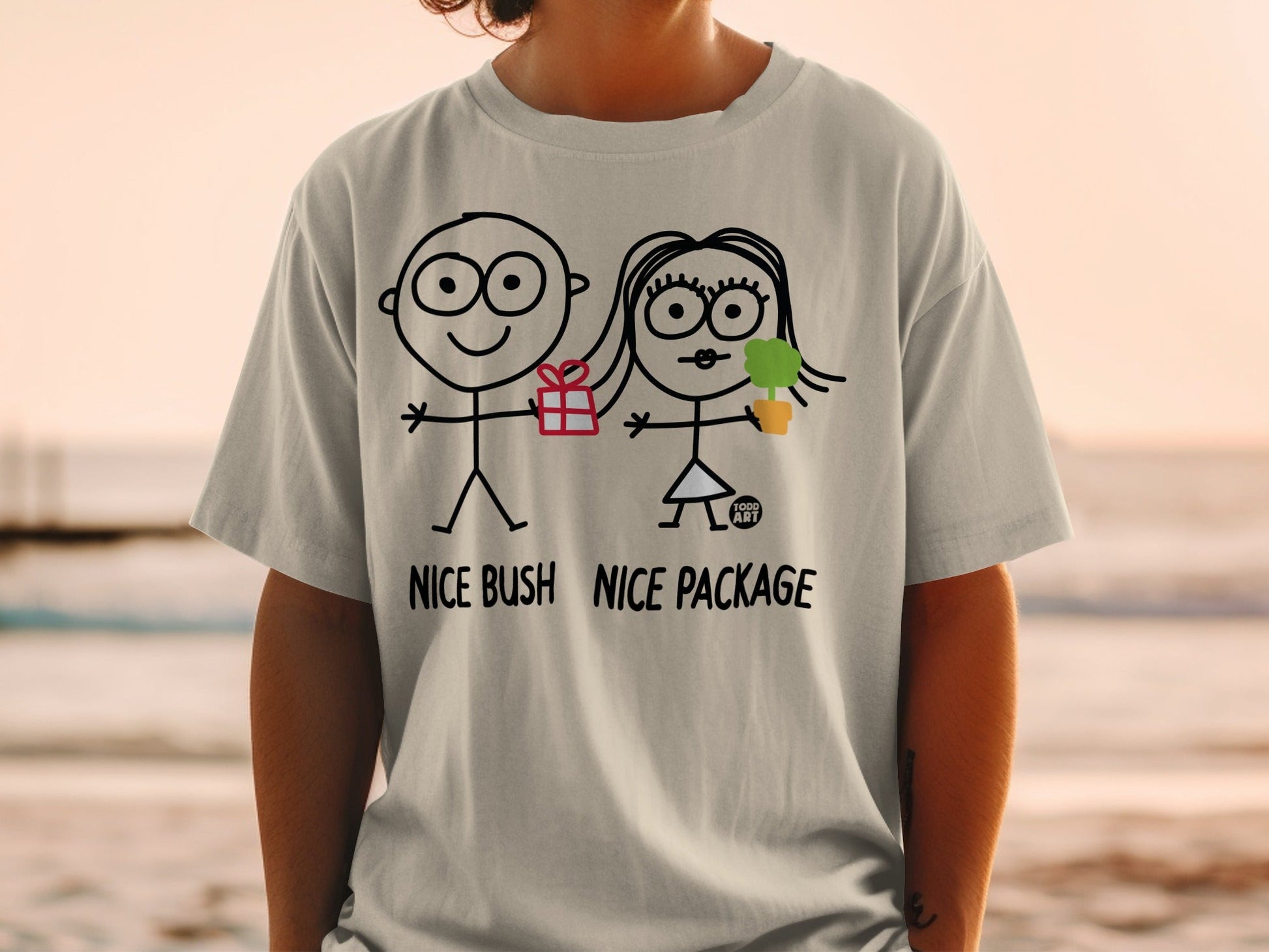 T-shirt with stick figures holding a gift and plant, text "NICE BUSH NICE PACKAGE".