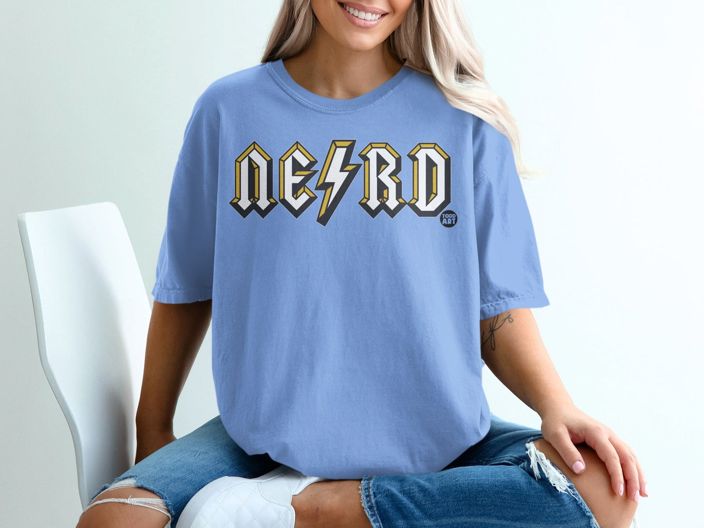 Light blue t-shirt with "NERD" in yellow lightning bolt font.