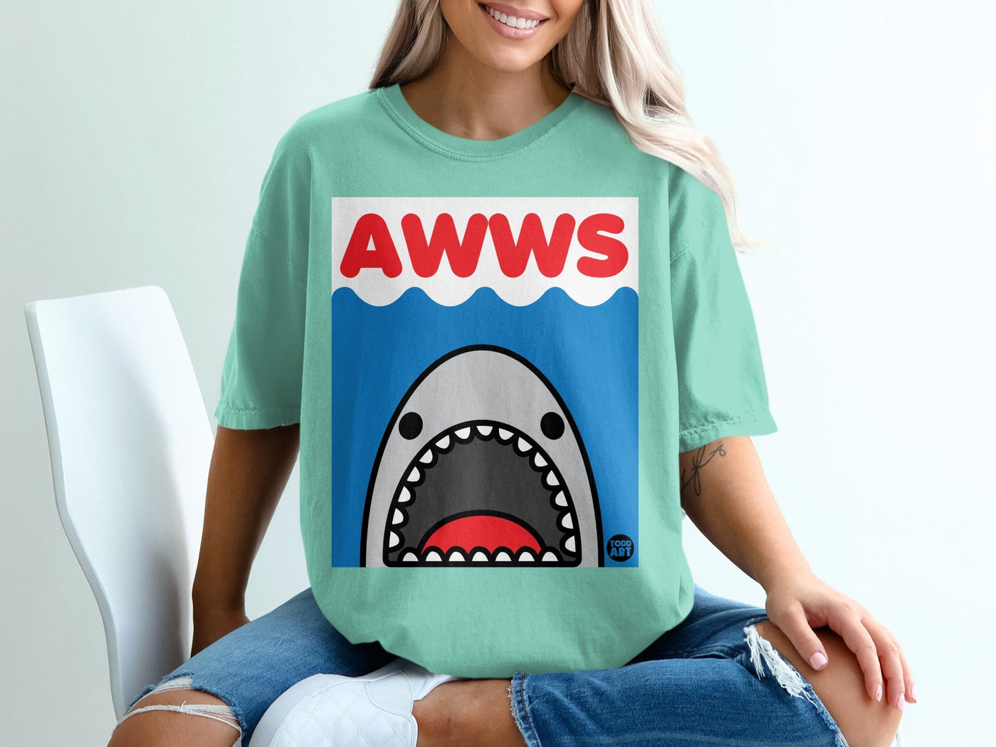 Green t-shirt with "AWWS" and a cartoon shark with open mouth.
