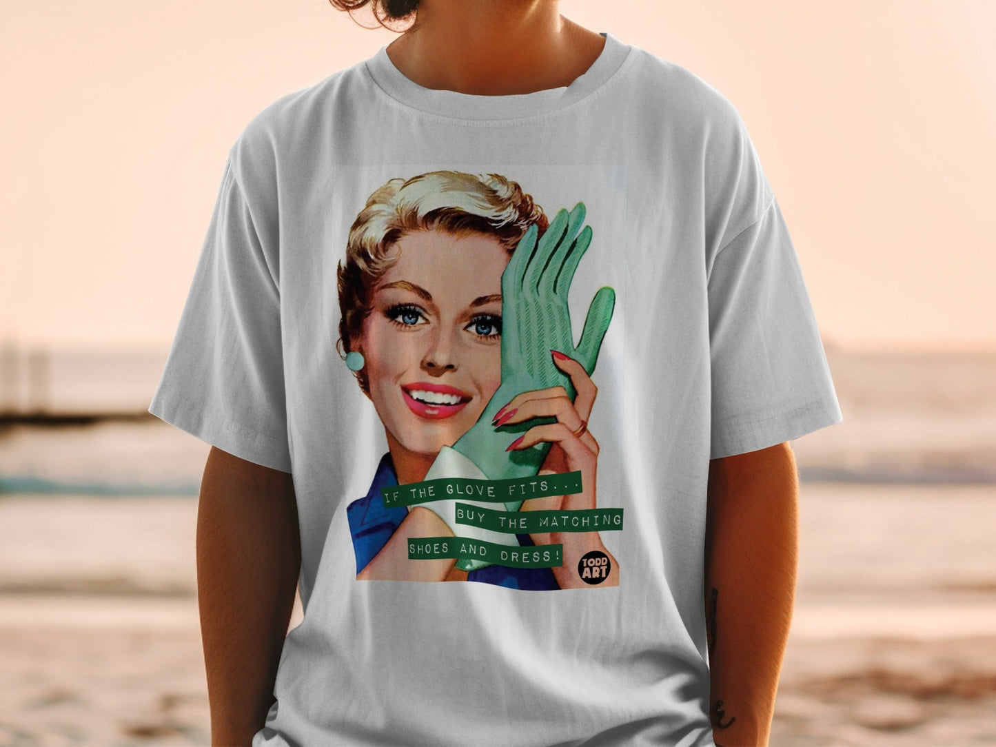 Retro woman in t-shirt holding a green glove, text "IF THE GLOVE FITS... BUY THE MATCHING SHOES AND DRESS!".