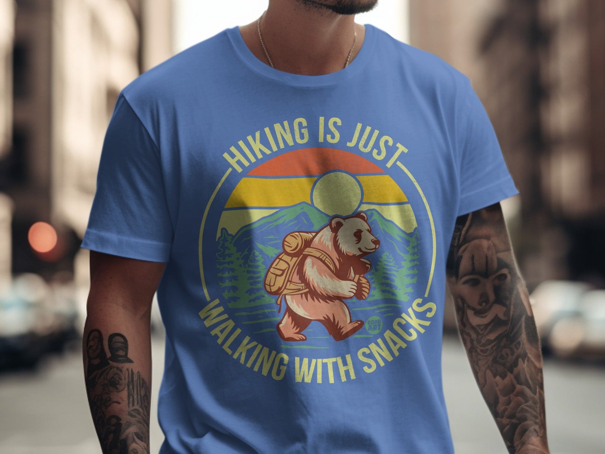 Blue t-shirt with bear hiking graphic and text "Hiking is just walking with snacks".