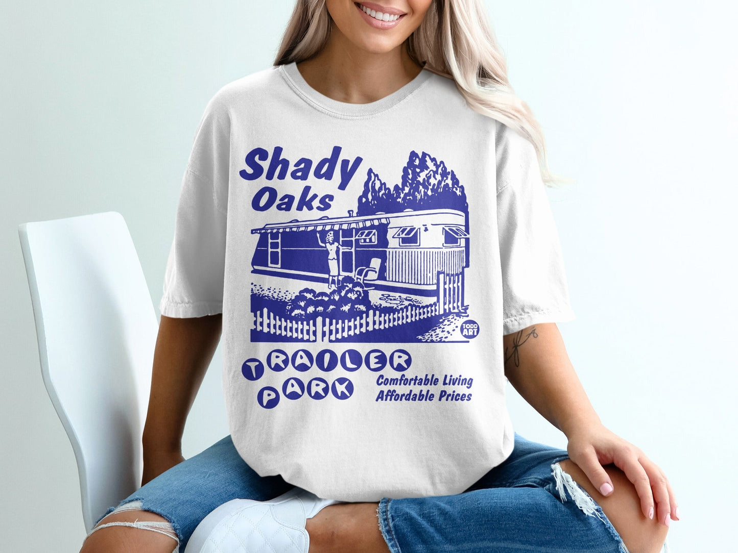 Shady Oaks Trailer Park graphic tee with vintage trailer and trees.