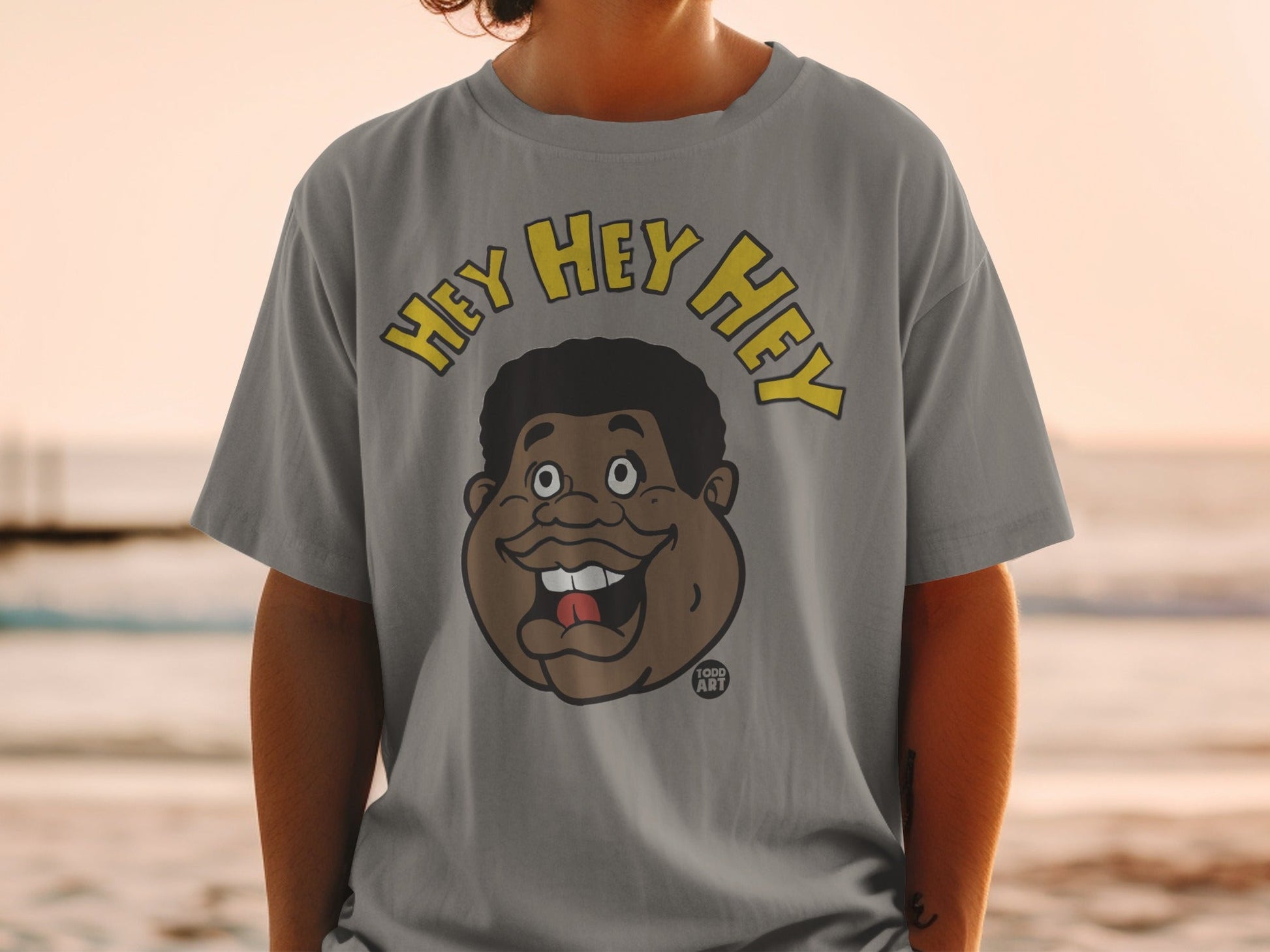 T-shirt with a cartoon of a man's face saying "Hey Hey Hey."