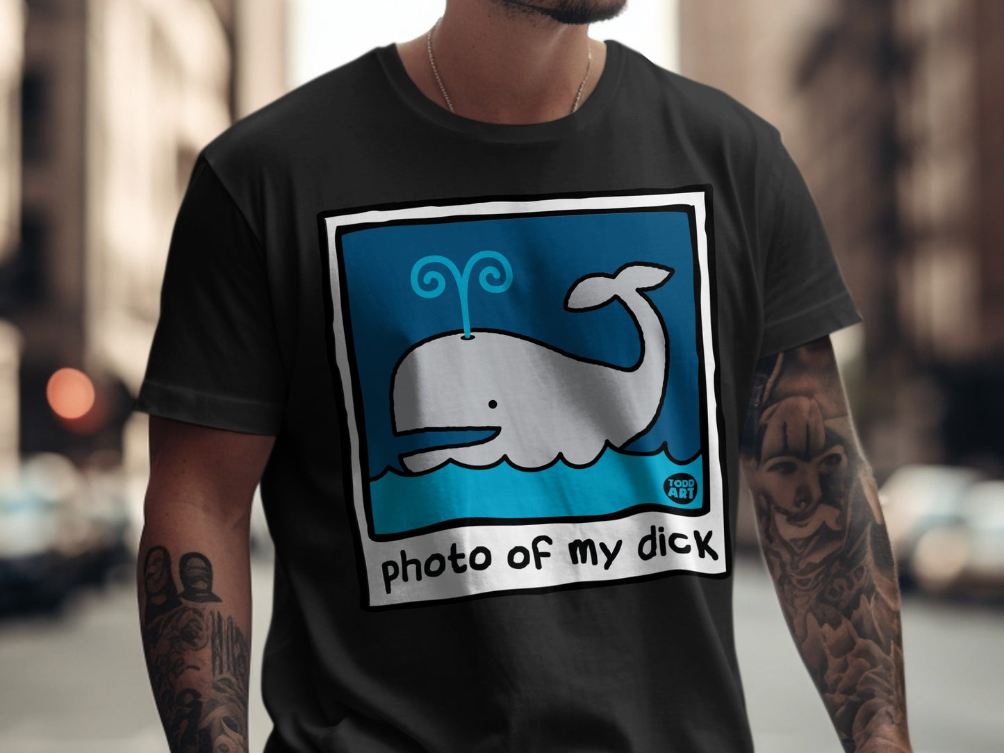 Grey whale graphic with "photo of my dick" text on a black t-shirt.