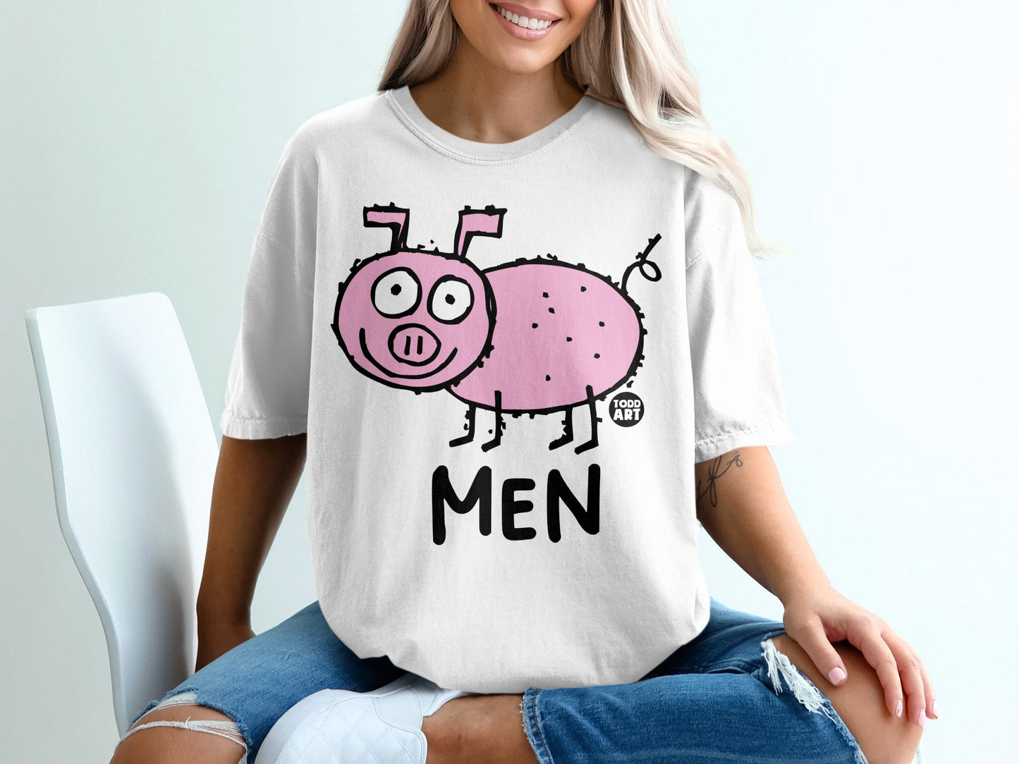 White t-shirt with a cartoon pink pig and the word "MEN".