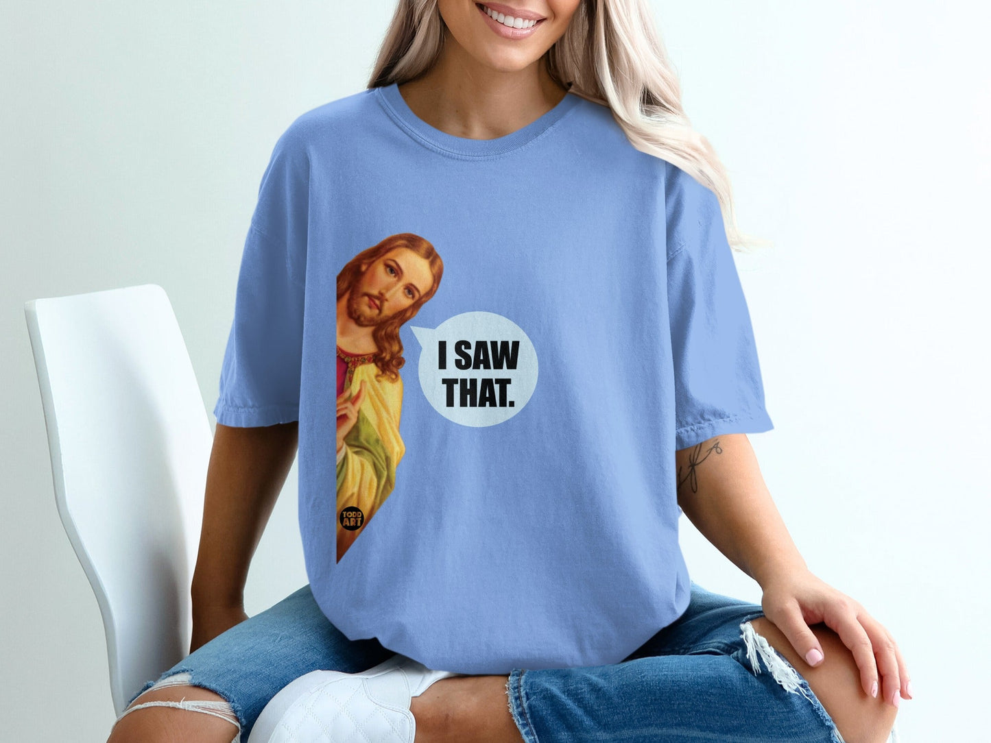 Blue t-shirt with Jesus graphic saying "I SAW THAT."