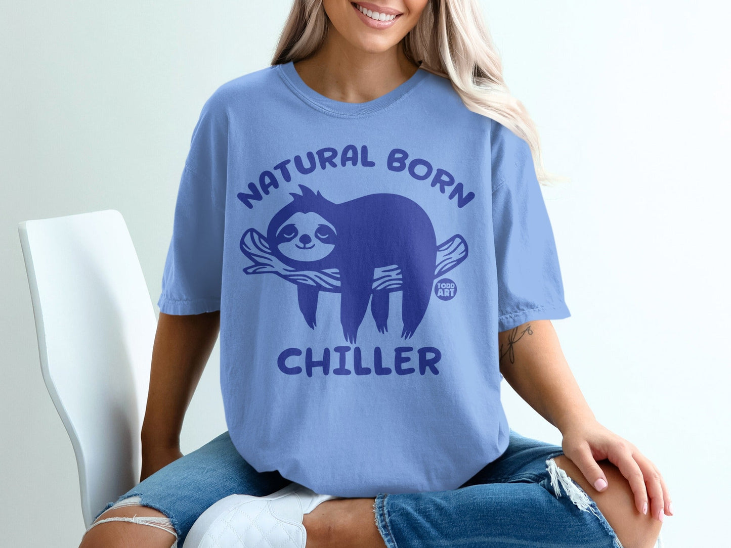 Comfort Colors blue t-shirt with "Natural Born Chiller" sloth graphic.