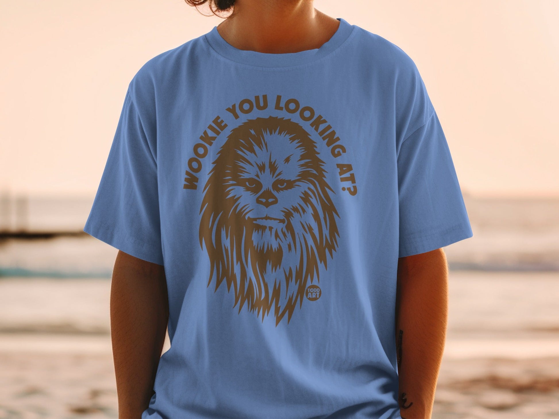 Wookiee You Looking At? graphic on a blue t-shirt worn by a person.