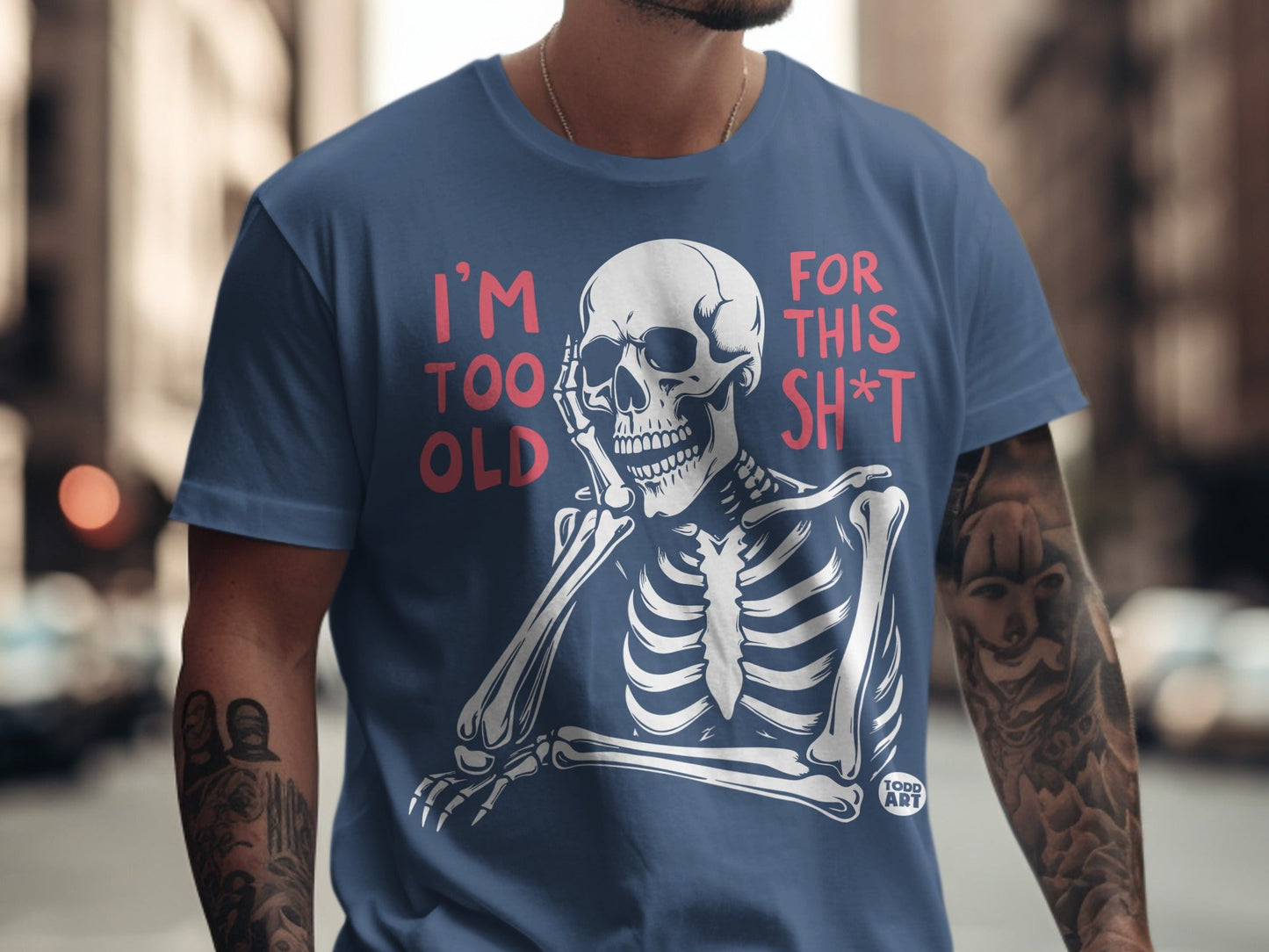 Skeleton graphic with text "I'm too old for this sh*t" on a navy t-shirt.
