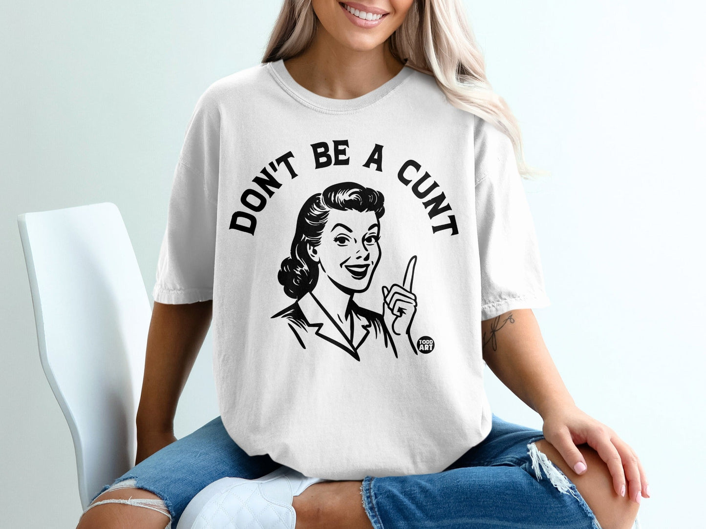 White t-shirt with "Don't be a cunt" text and vintage woman graphic.