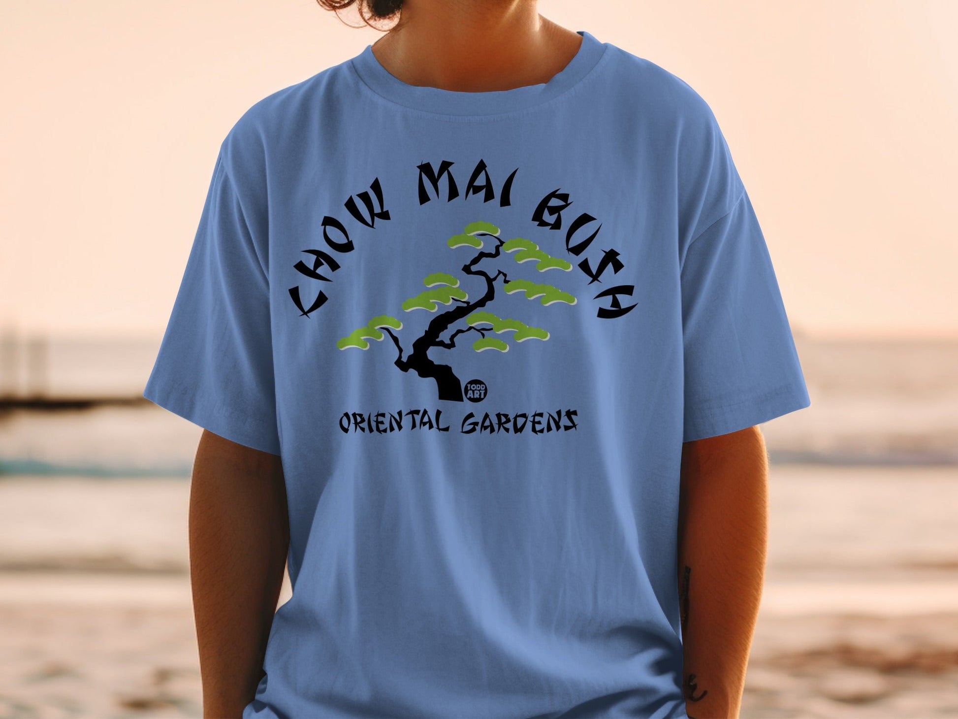 Blue t-shirt with "CHOW MAI BOJI" and "ORIENTAL GARDENS" text, featuring a bonsai tree.