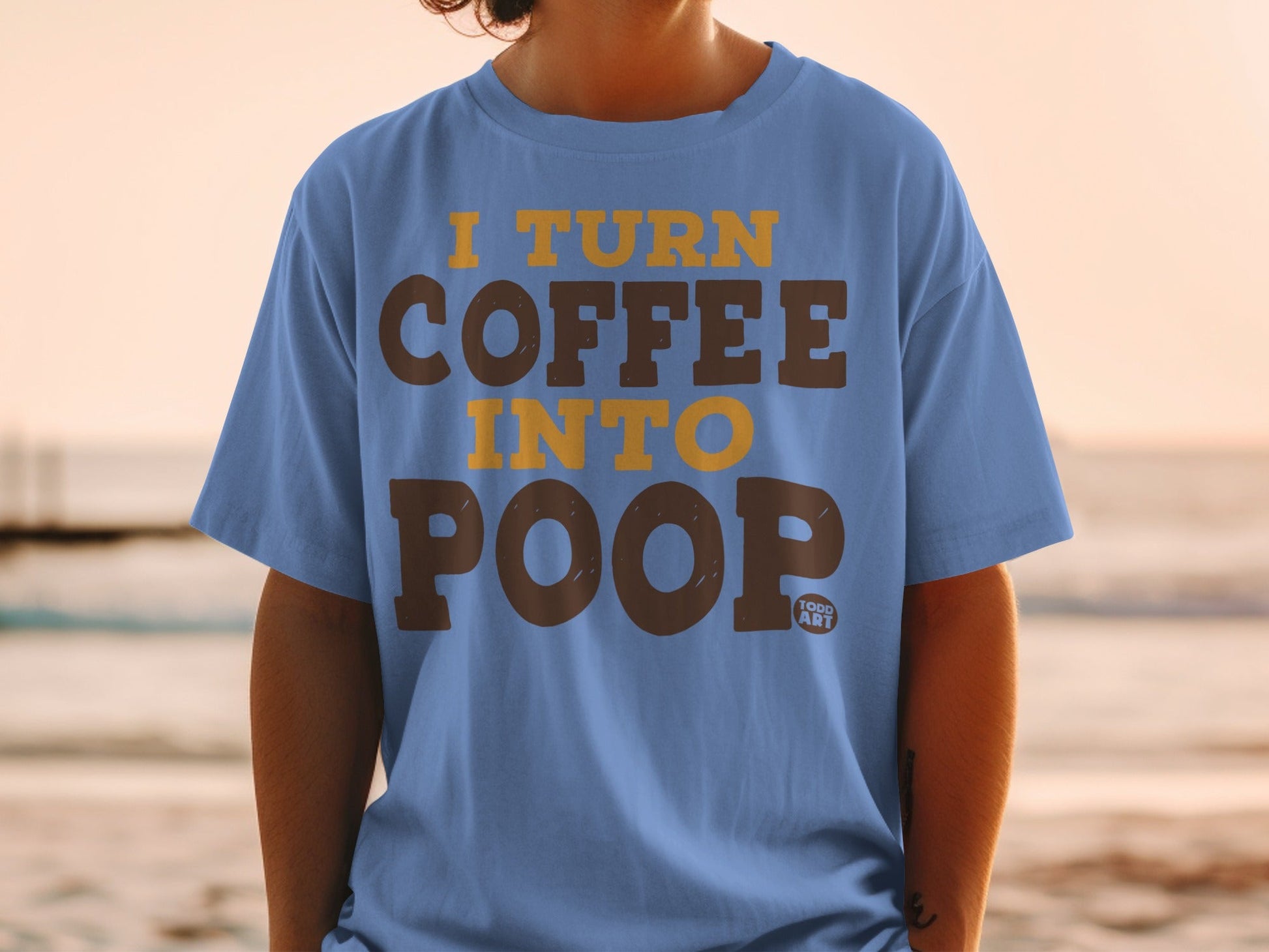 Blue t-shirt with "I TURN COFFEE INTO POOP" text.