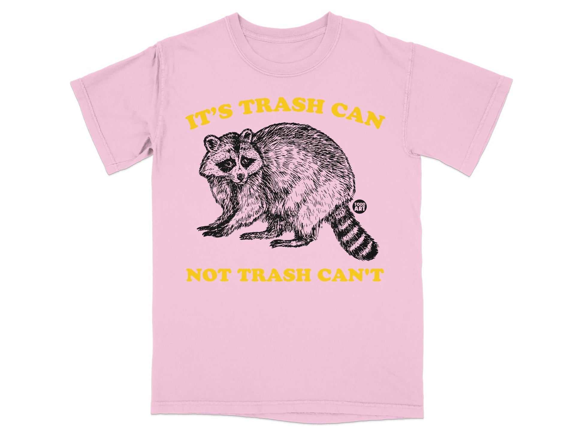 Pink t-shirt with a raccoon graphic and text "IT'S TRASH CAN NOT TRASH CAN'T".