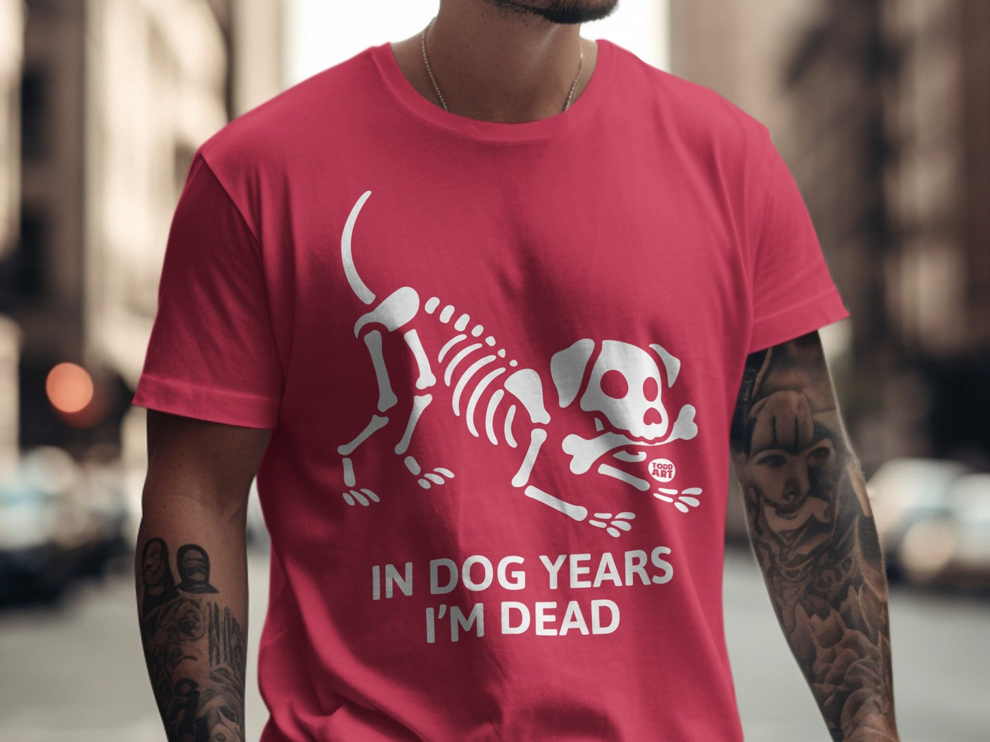 Red t-shirt with white dog skeleton graphic and text "IN DOG YEARS I'M DEAD".
