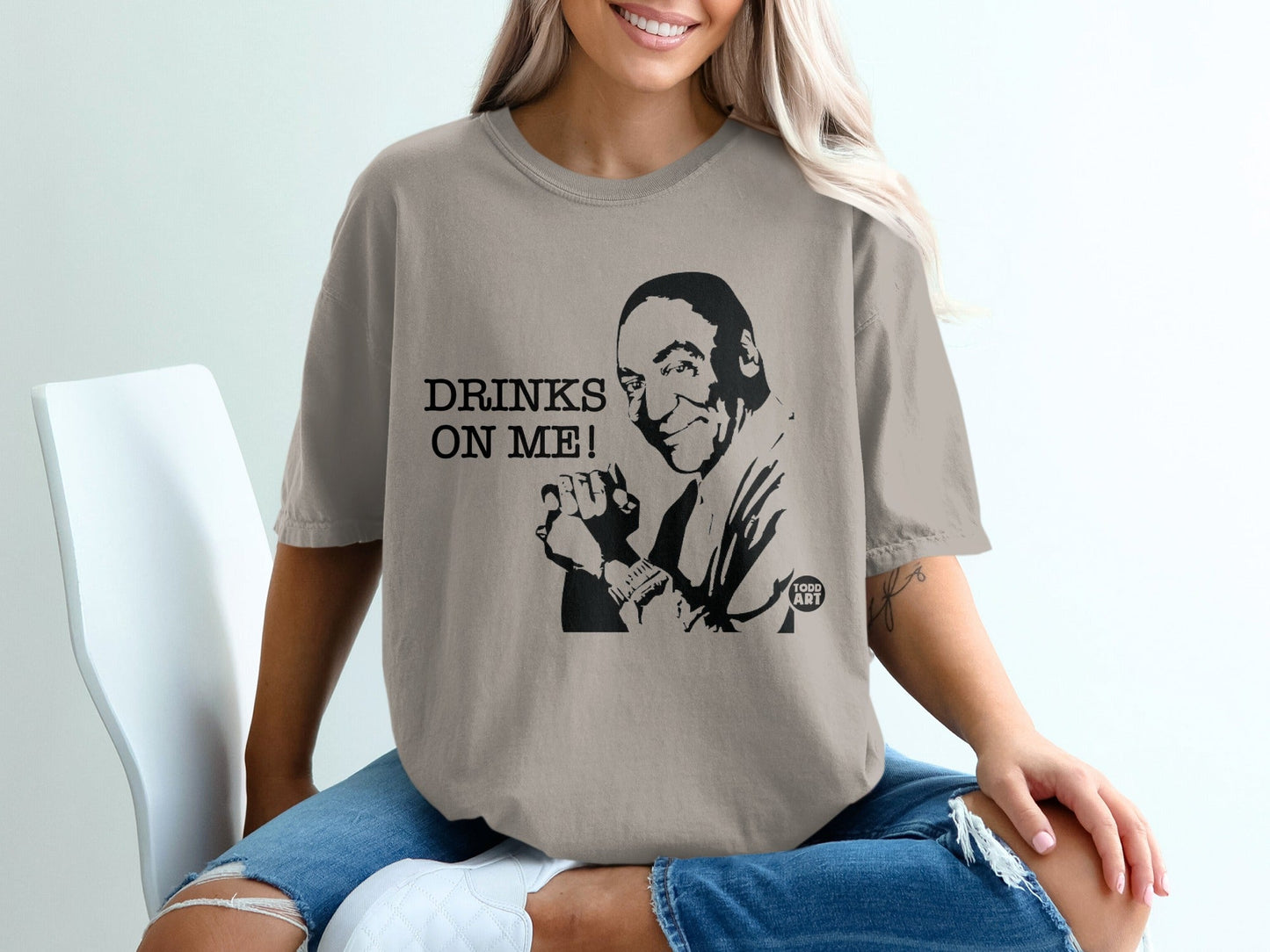 T-shirt with black illustration and text "DRINKS ON ME!".