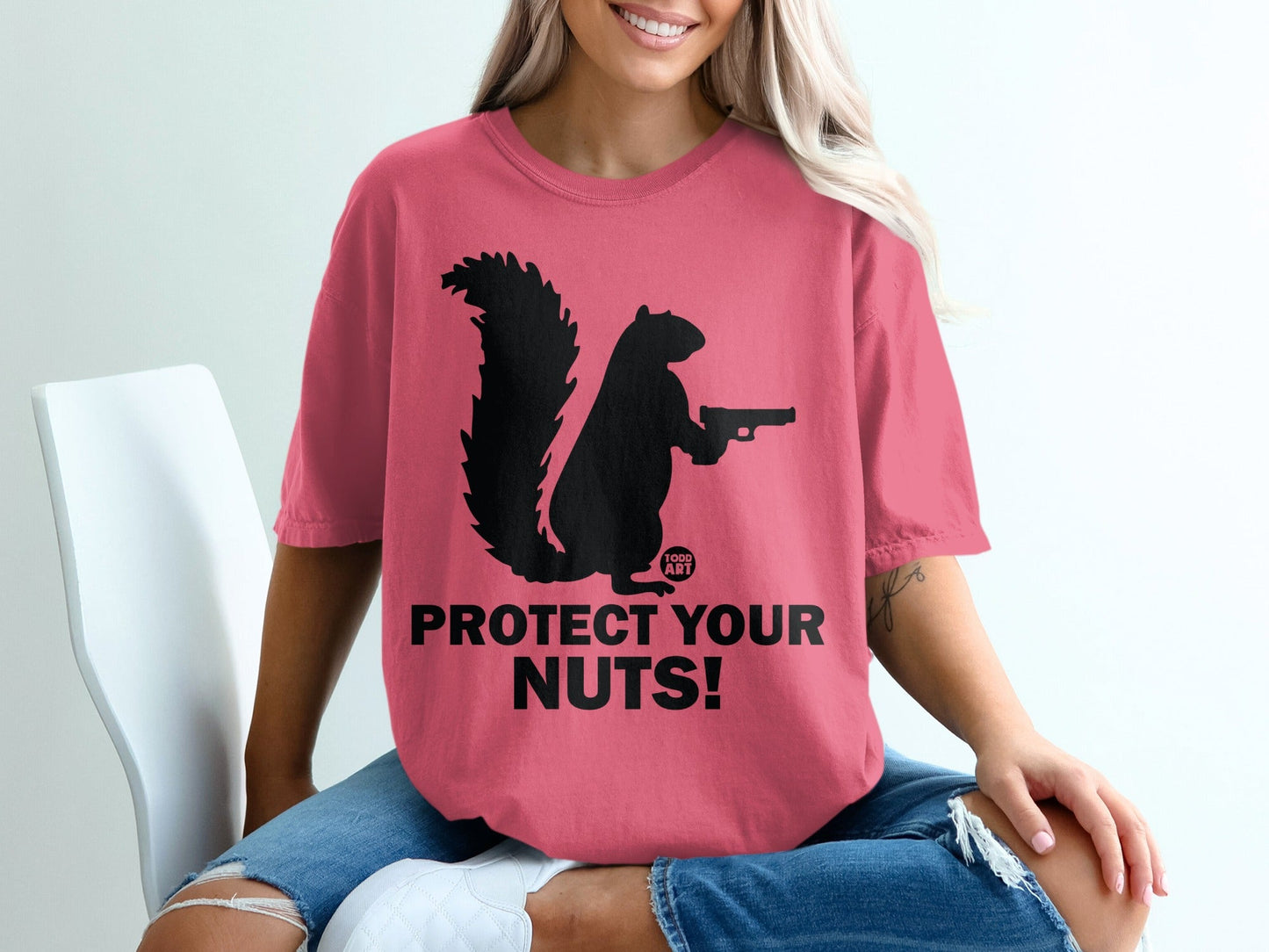 Black squirrel holding a pistol with text "PROTECT YOUR NUTS!"