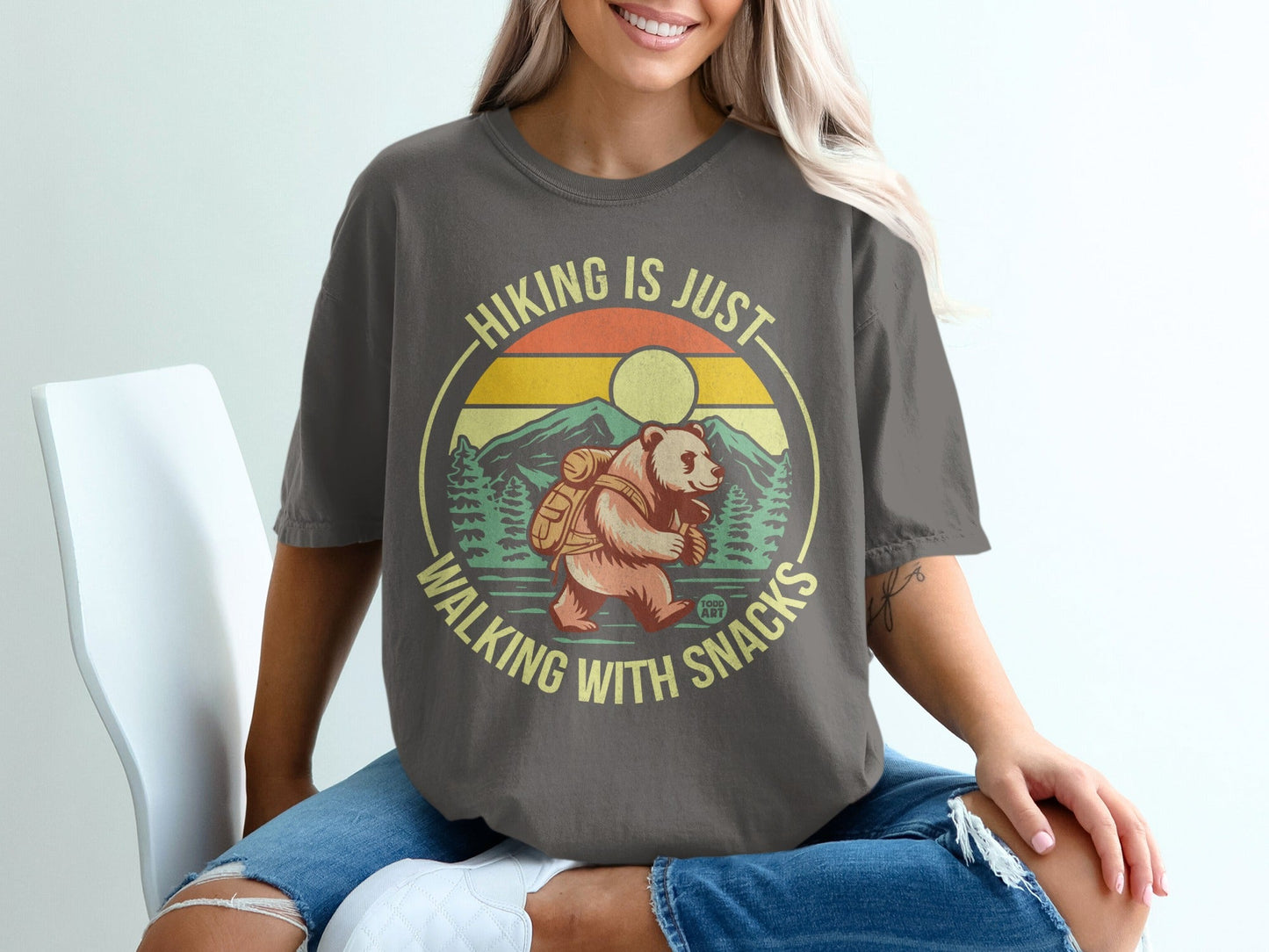 Bear with backpack on shirt, "Hiking is just walking with snacks" text.