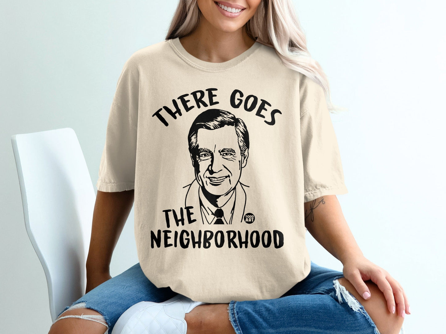 T-shirt with Fred Rogers' portrait and "THERE GOES THE NEIGHBORHOOD" text.