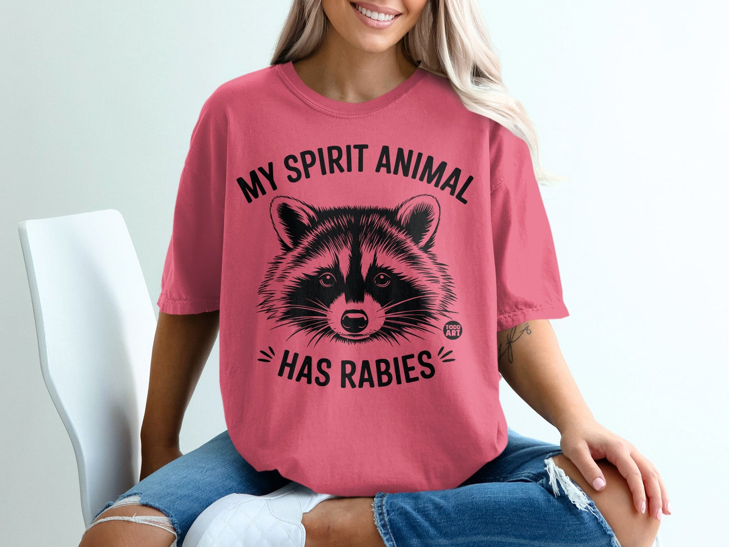 Pink t-shirt with raccoon graphic and "My Spirit Animal Has Rabies" text.