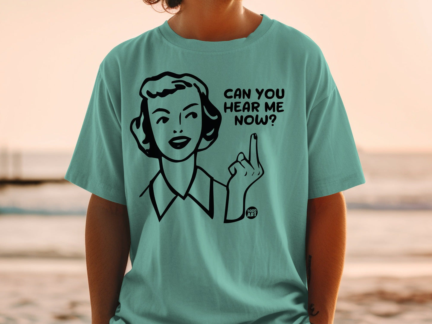 Teal t-shirt with a cartoon woman asking "Can you hear me now?".