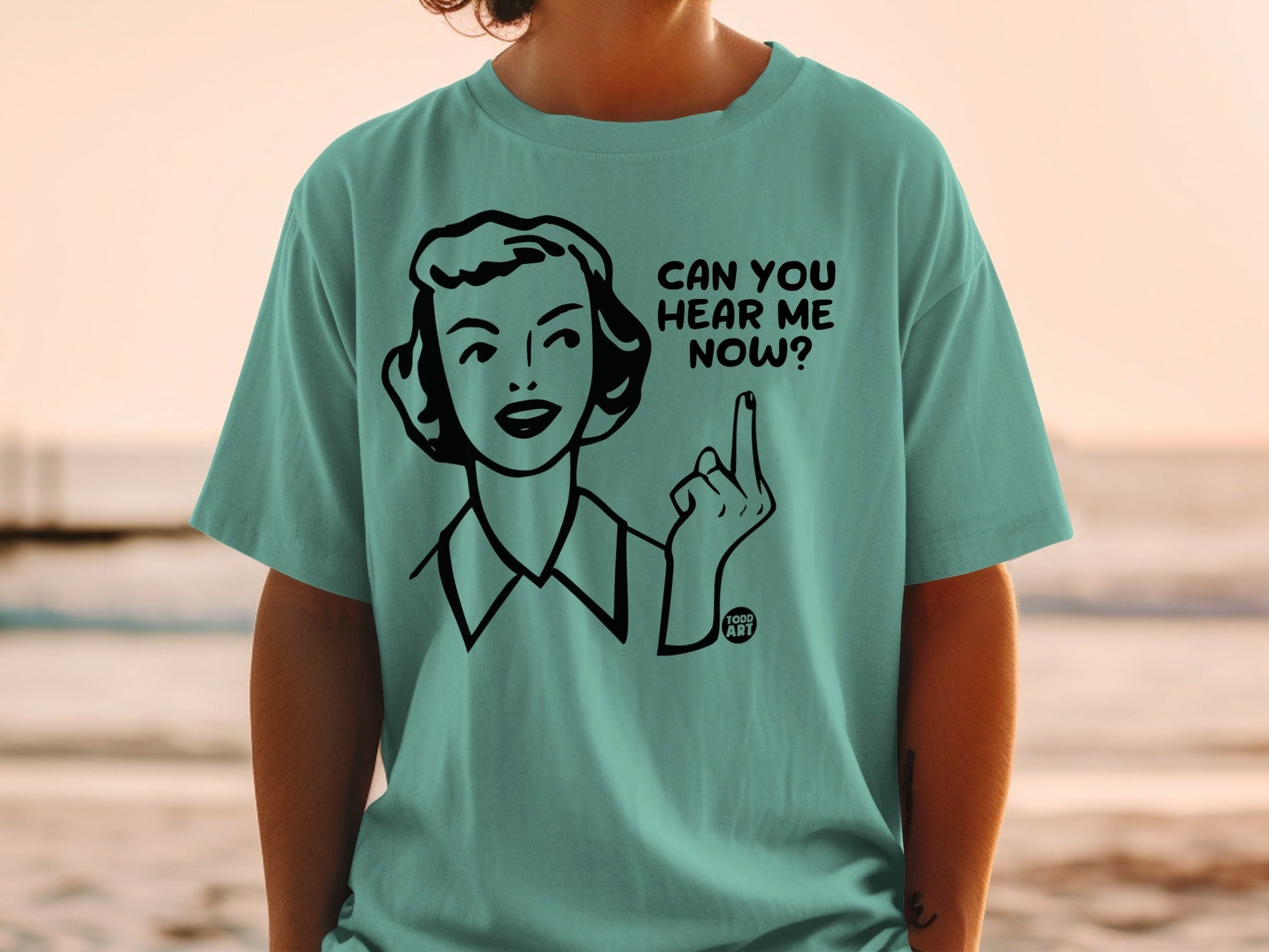 Teal t-shirt with a cartoon woman asking "Can you hear me now?".