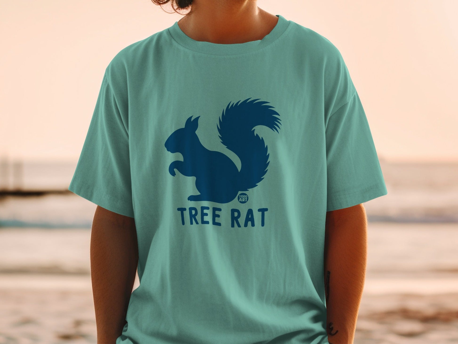 Teal t-shirt with a dark blue squirrel silhouette and "TREE RAT" text.