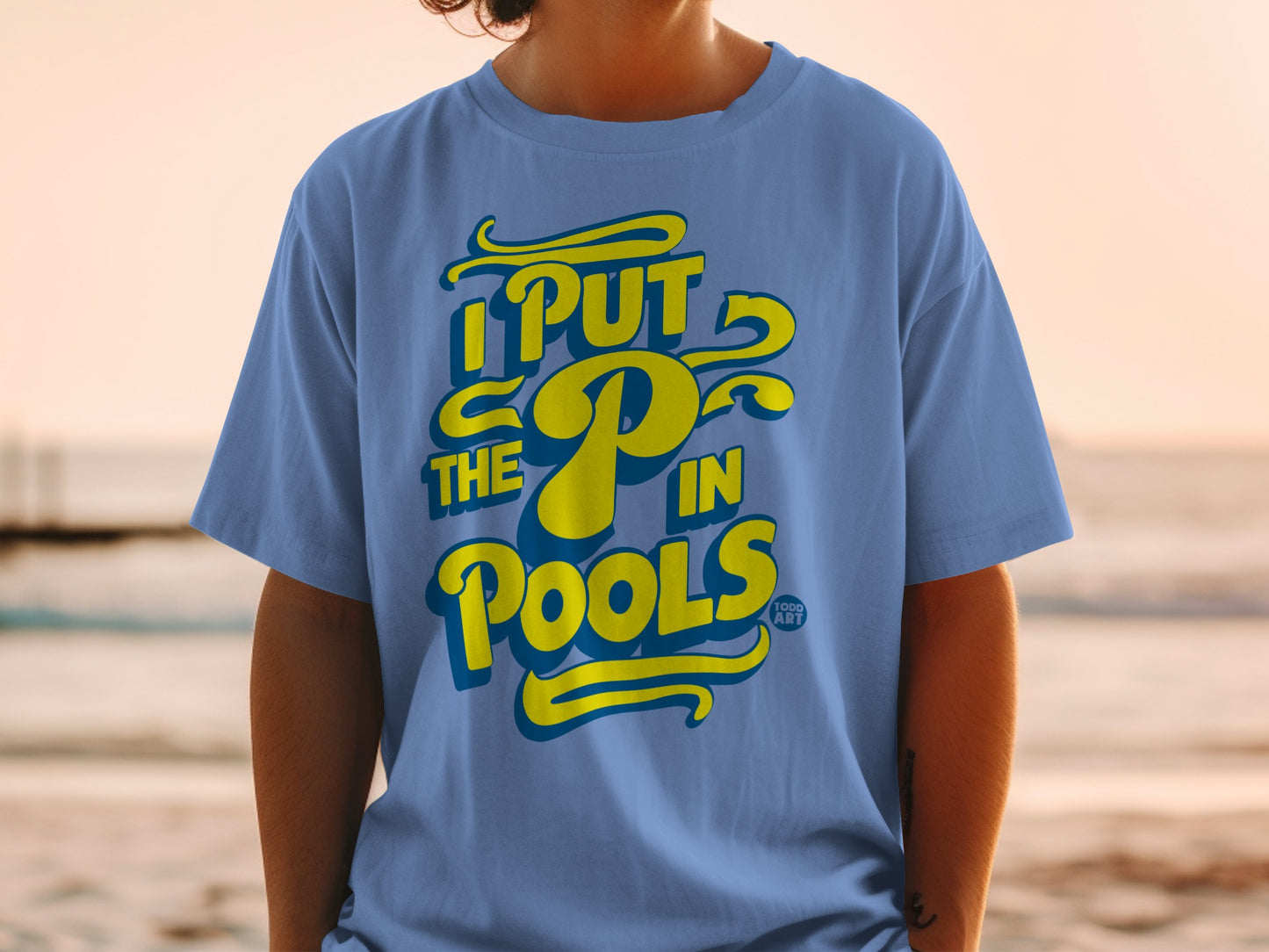 Blue t-shirt with yellow text reading "I PUT THE P IN POOLS".
