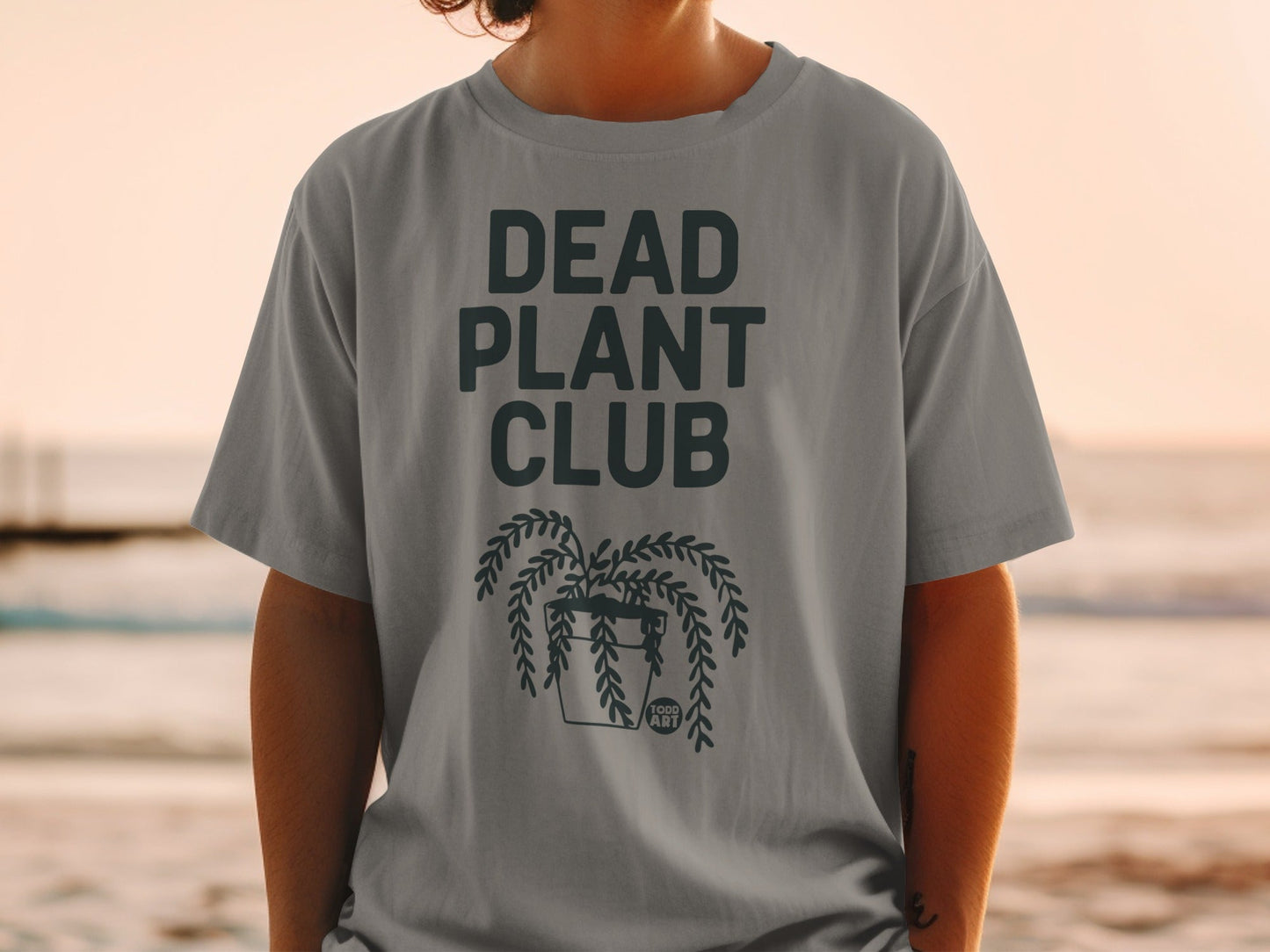 Gray t-shirt with "DEAD PLANT CLUB" and a hanging potted plant.