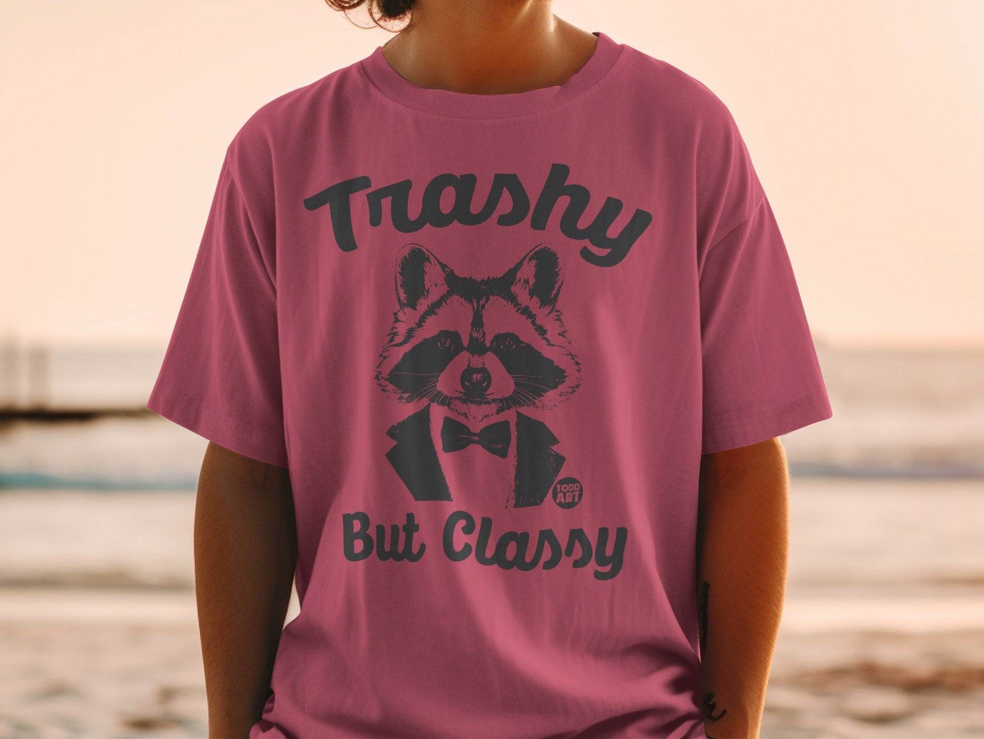 T-shirt with raccoon wearing a bow tie and the text "Trashy But Classy"