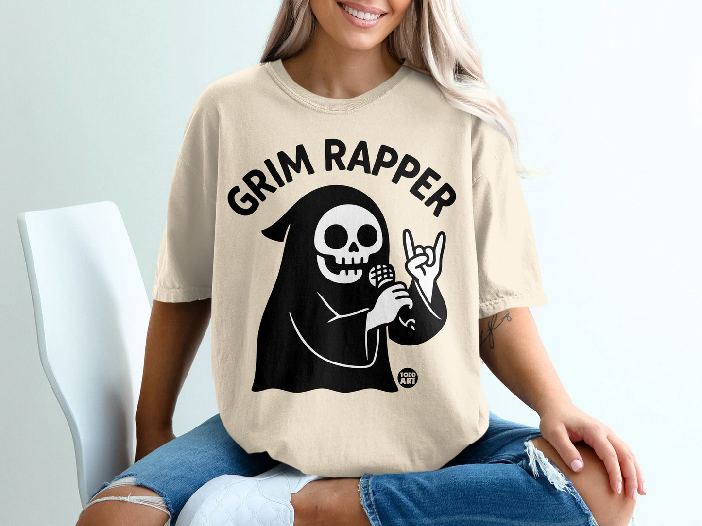 Grim Reaper character in black hoodie with "Grim Rapper" text, holding microphone.