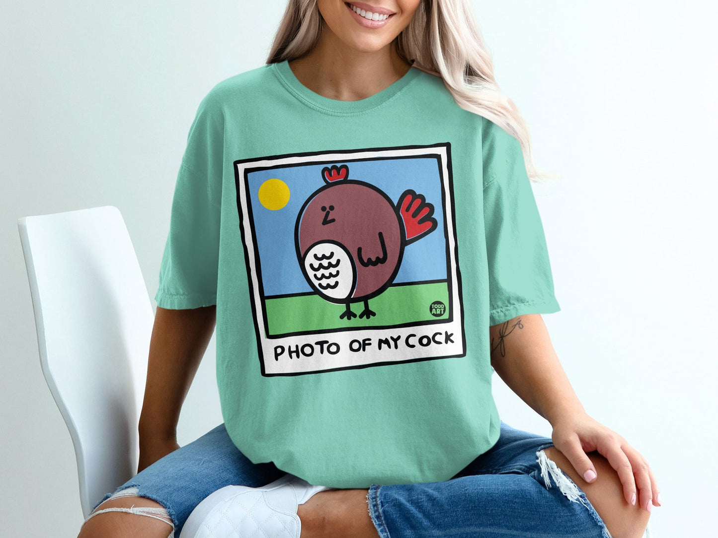 Cartoon chicken in a frame with text "PHOTO OF MY COCK" below.