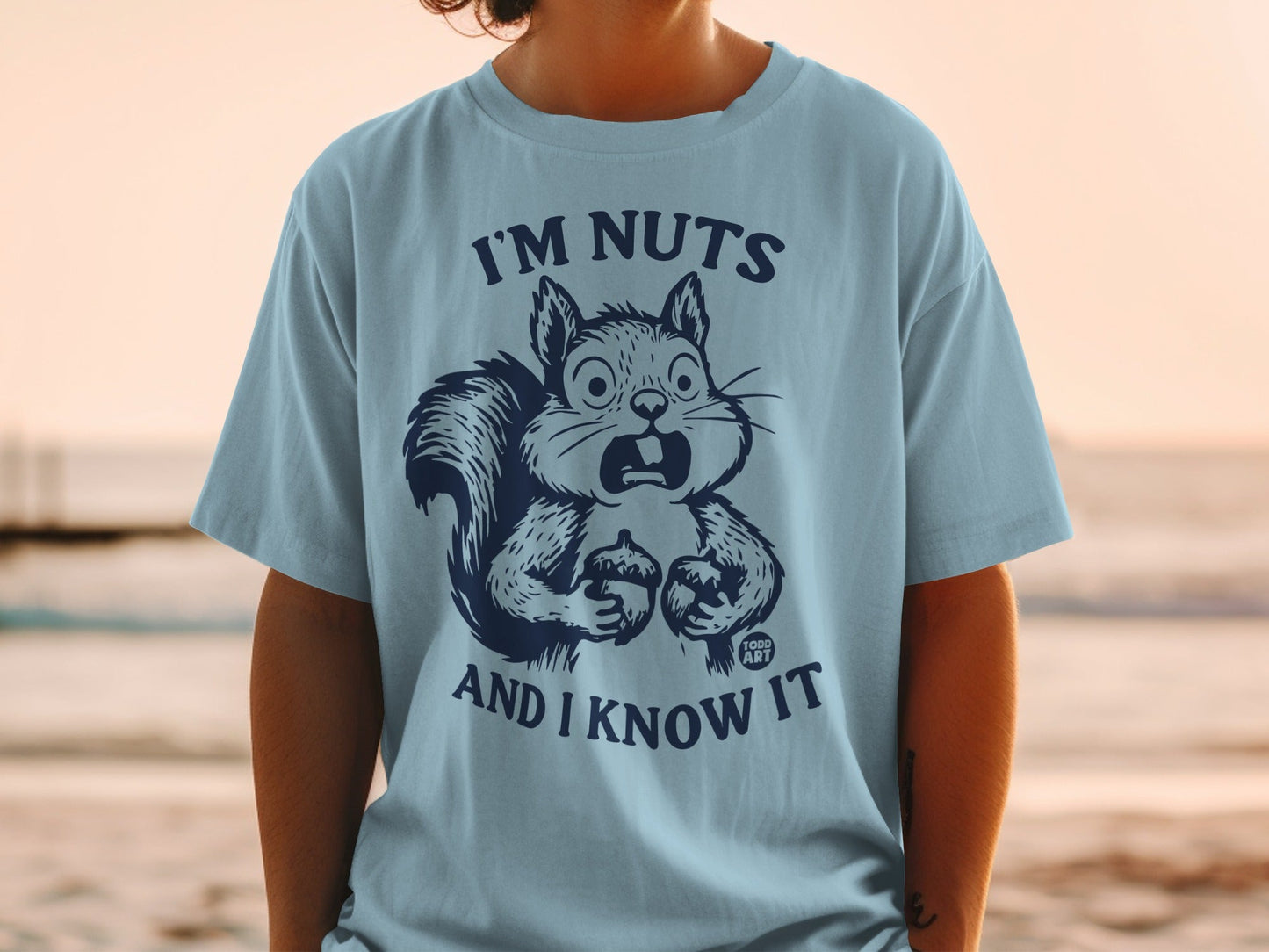 Light blue t-shirt with a surprised squirrel graphic and text "I'm nuts and I know it".