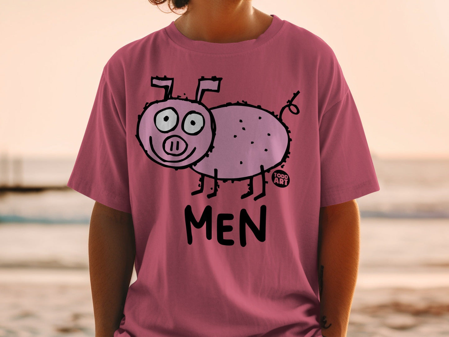 Pink t-shirt with a cartoon pig and "TODD ART" and "MEN" text.