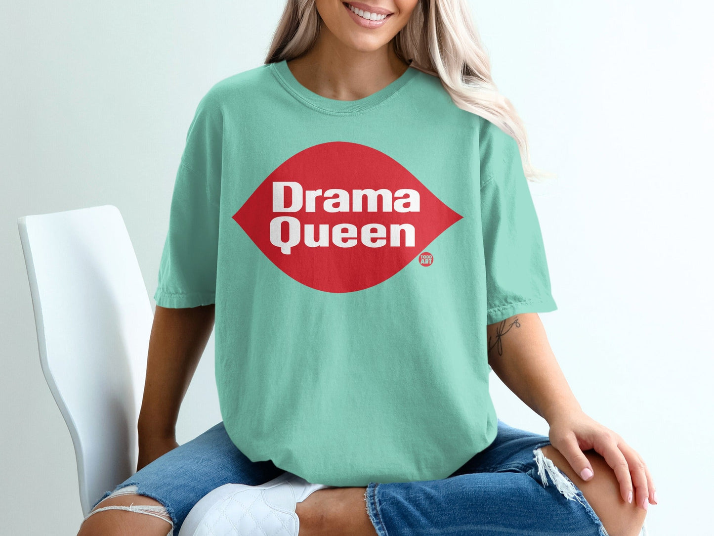 Mint t-shirt with red diamond logo that says "Drama Queen" and "ART".