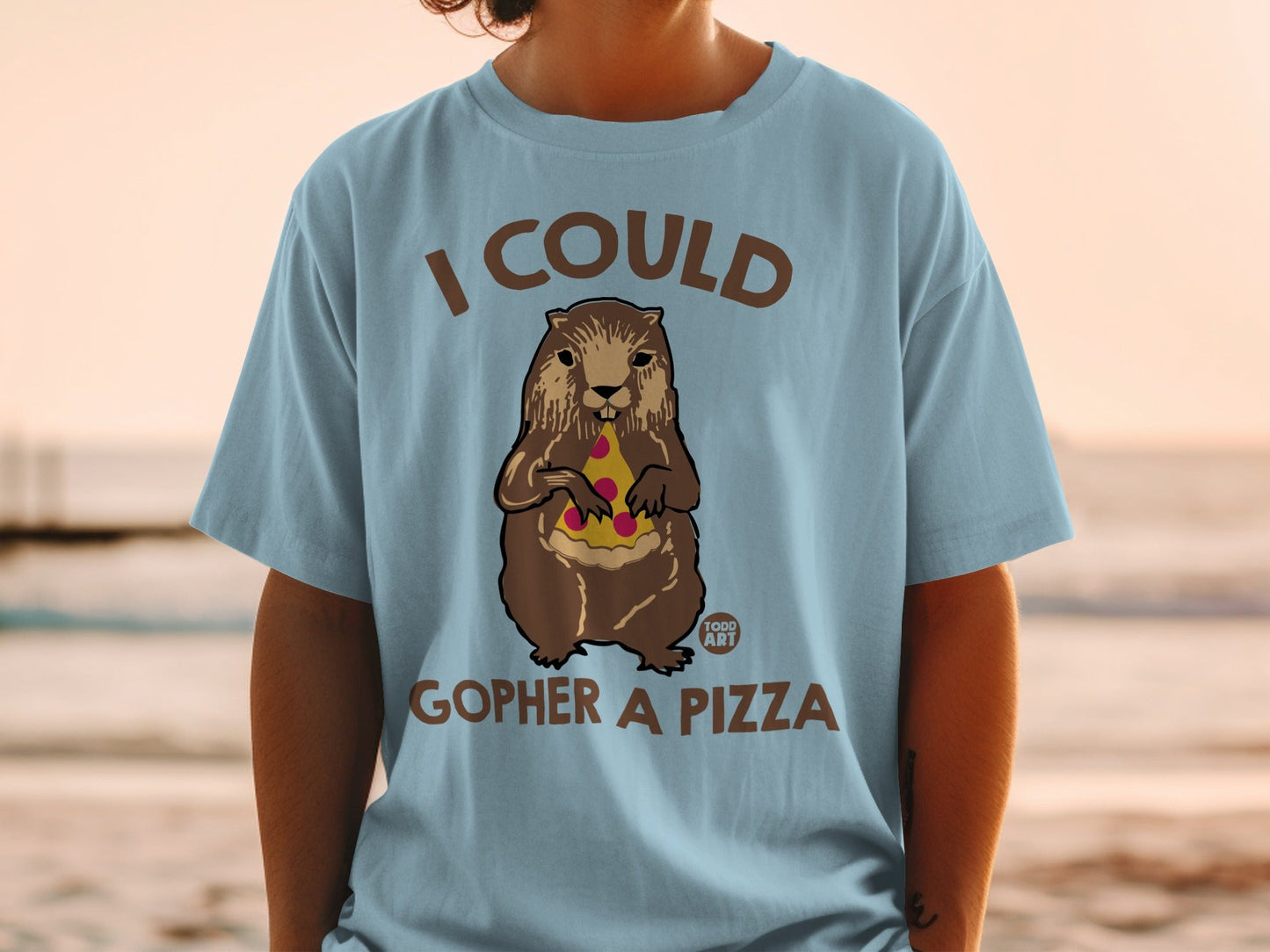 Groundhog wearing a shirt saying "I could gopher a pizza" holding pizza.