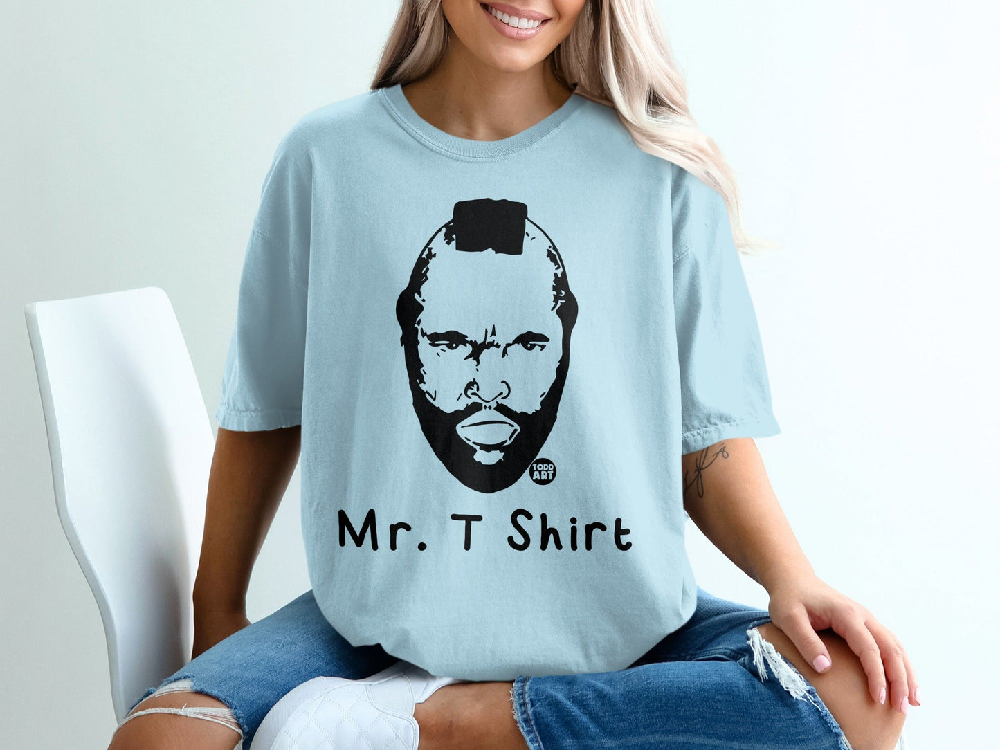 Light blue t-shirt with Mr. T's face and "ART" logo, text reads "Mr. T Shirt".