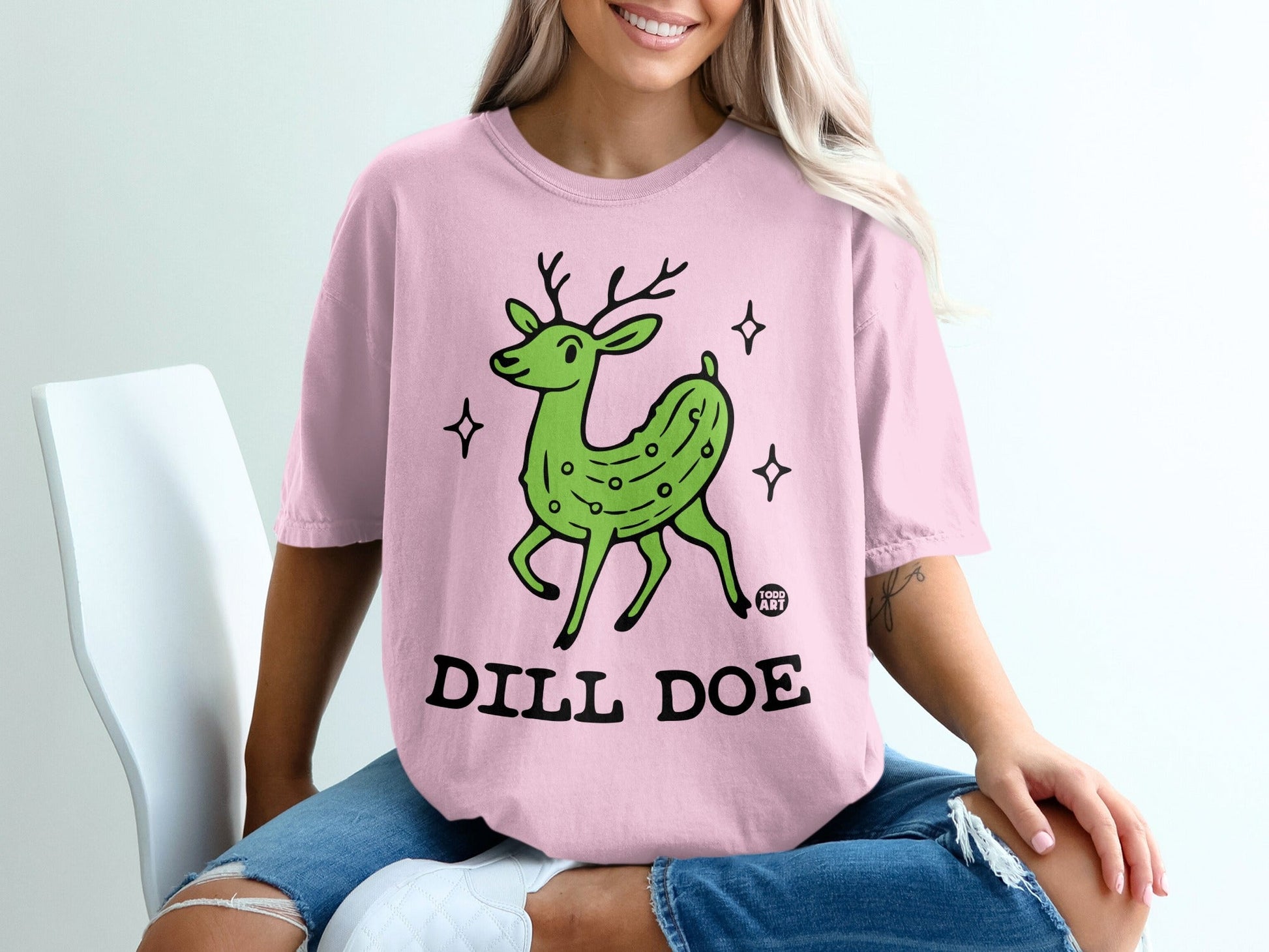 Pink t-shirt with a green pickle deer graphic and "DILL DOE" text.