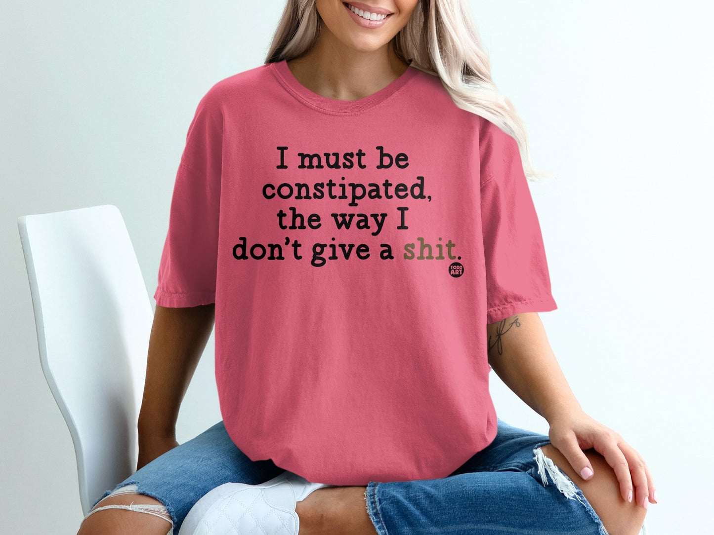 Coral t-shirt with text "I must be constipated, the way I don't give a shit."