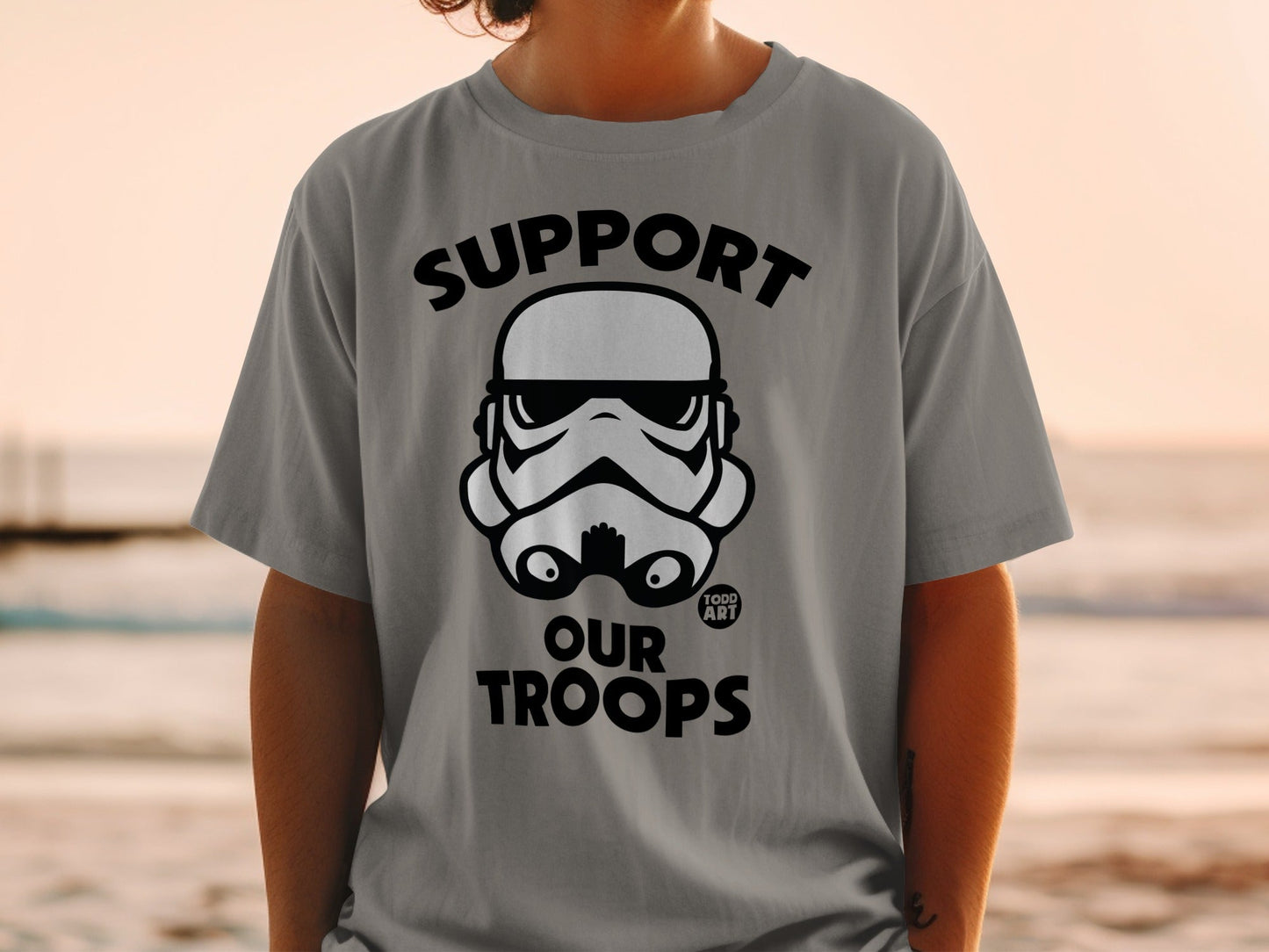 Gray t-shirt with black "Support Our Troops" text and Stormtrooper helmet graphic.