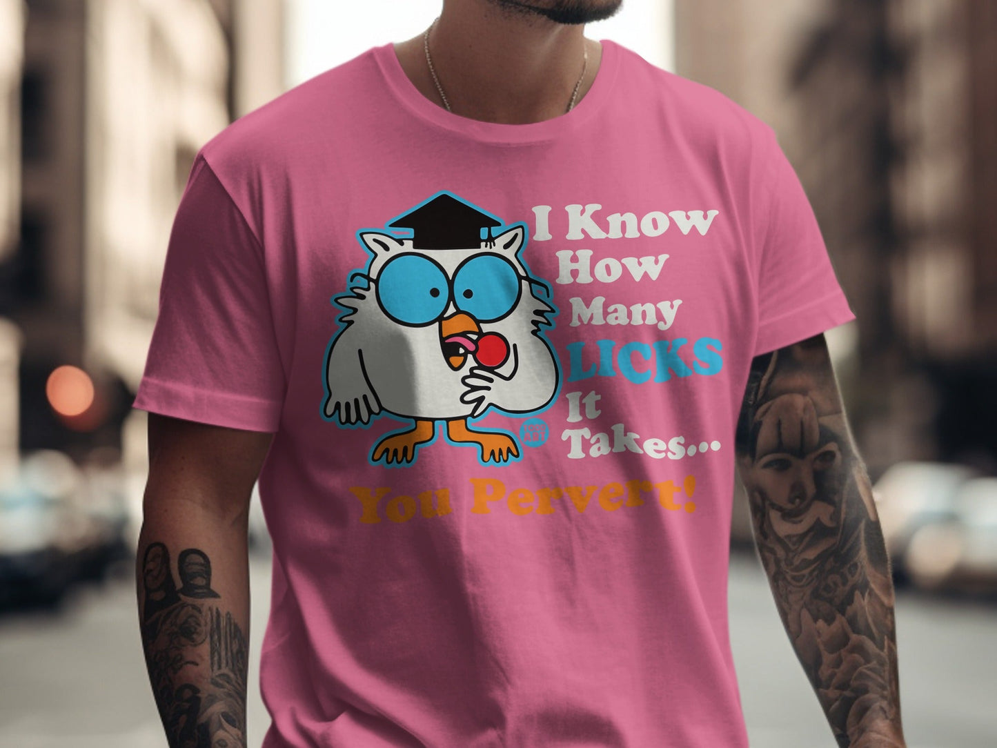 Pink t-shirt with a cartoon owl wearing a graduation cap and glasses, saying "I Know How Many Licks It Takes... You Pervert!".