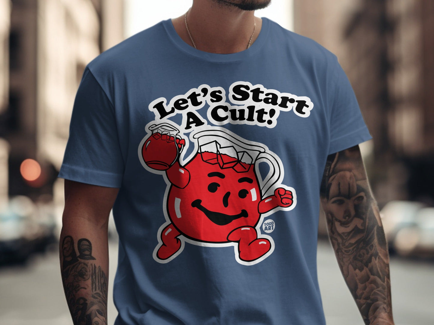 Kool-Aid Man t-shirt with "Let's Start a Cult!" text on blue shirt.