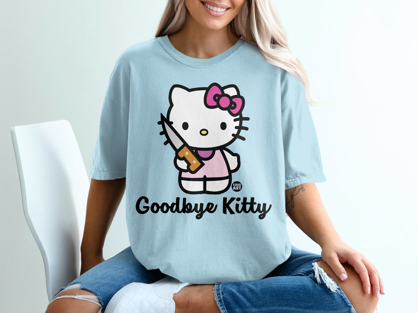 Light blue t-shirt with Hello Kitty holding a knife, "Goodbye Kitty" text.